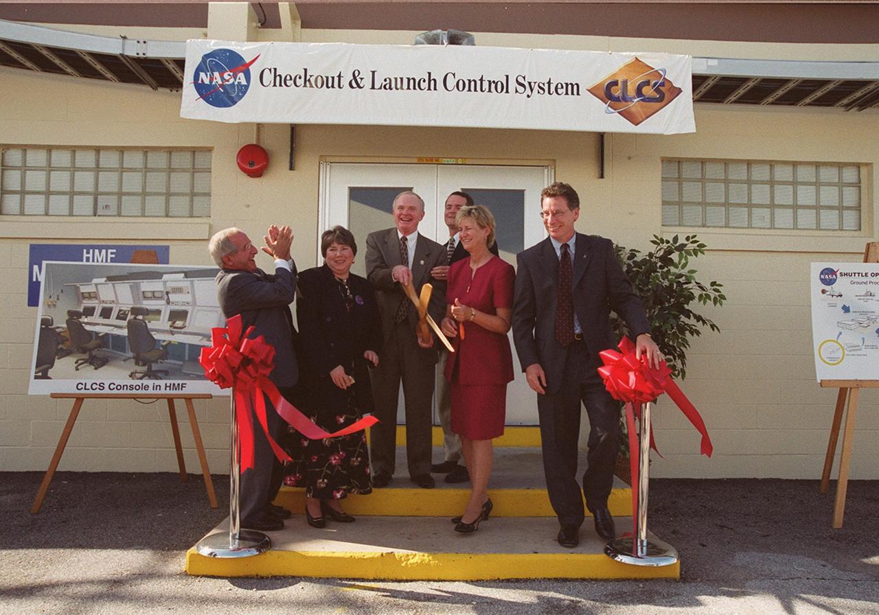 The ribbon is cut and the new Checkout and Launch Control System (CLCS) declared operational. Those taking part in the ceremony are (from left) Joseph Rothenberg, NASA Associate Administrator for Space Flight; Pam Gillespie, from Rep. Dave Weldon's office; Roy Bridges, Kennedy Space Center director; Dave King, director of Shuttle Processing; Retha Hart, deputy associate director, Spaceport Technology Management Office; and Ron Dittemore, manager, Space Shuttle Program. The new control room will be used to process the Orbital Maneuvering System pods and Forward Reaction Control System modules at the HMF. This hardware is removed from Space Shuttle orbiters and routinely taken to the HMF for checkout and servicing