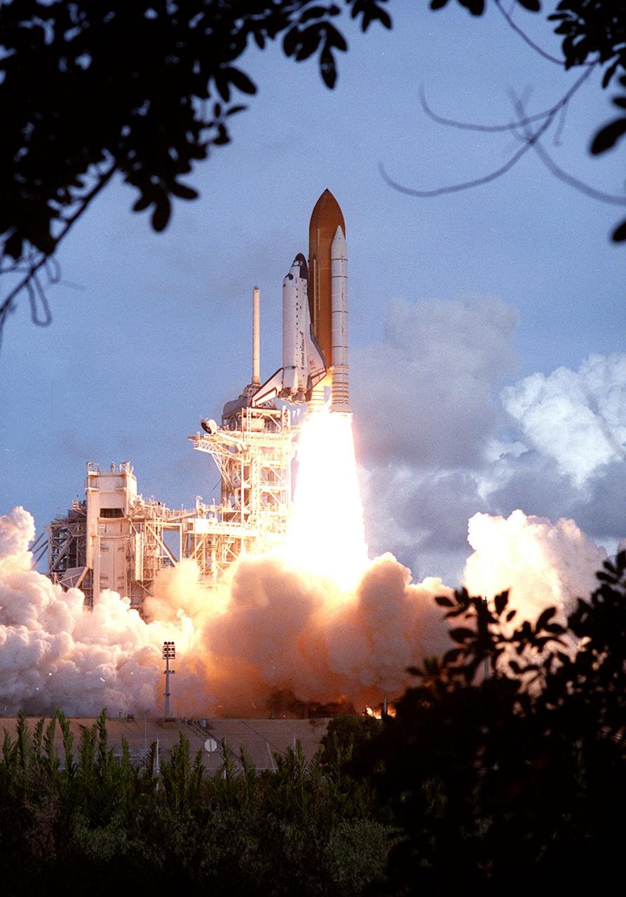 KENNEDY SPACE CENTER, Fla. -- Space Shuttle Atlantis appears to burst forth from a cocoon of smoke in the Florida marsh lands as it rockets toward space on mission STS-106. The perfect on-time liftoff of Atlantis occurred at 8:45:47 a.m. EDT. On the 11-day mission to the International Space Station, the seven-member crew will perform support tasks on orbit, transfer supplies and prepare the living quarters in the newly arrived Zvezda Service Module. The first long-duration crew, dubbed “Expedition One,” is due to arrive at the Station in late fall. Landing of Atlantis is targeted for 4:45 a.m. EDT on Sept. 19