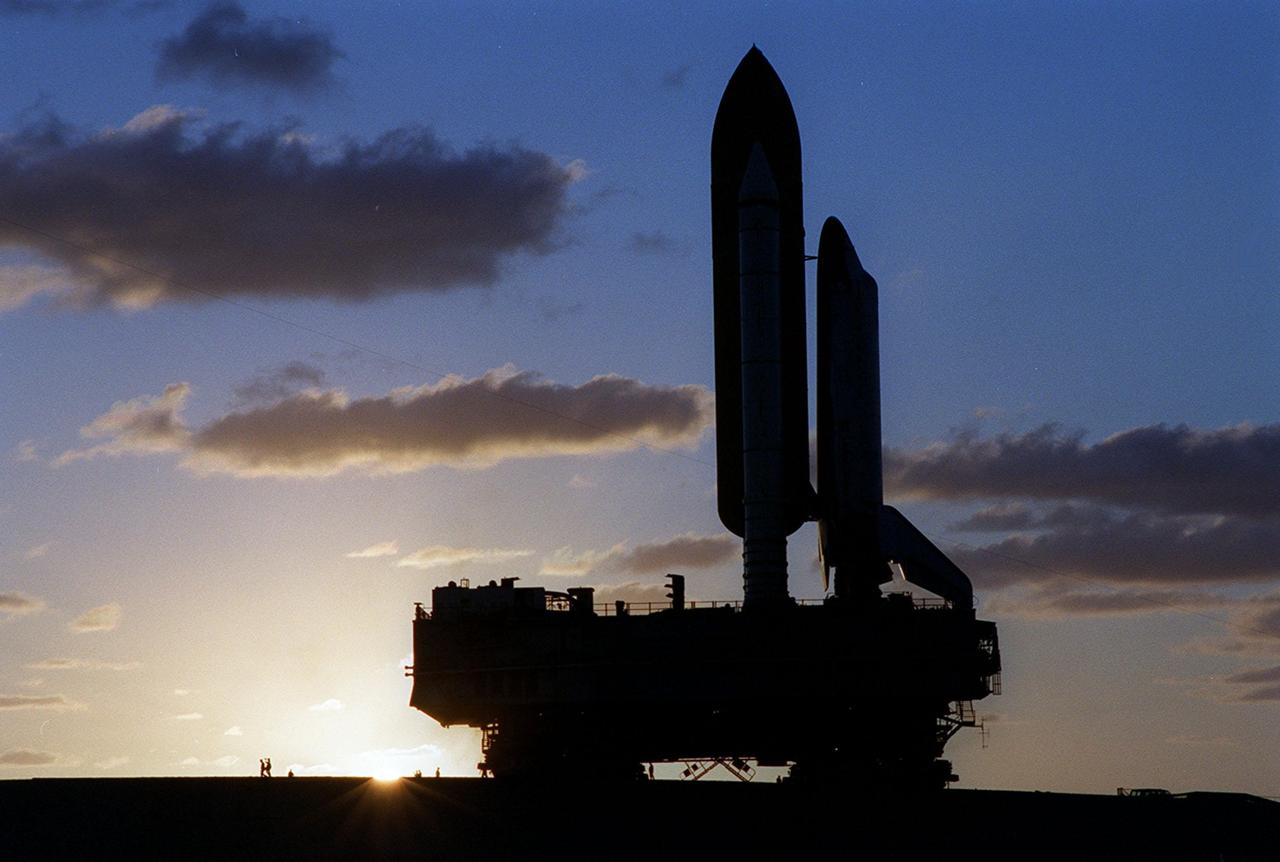 KENNEDY SPACE CENTER, Fla. -- Dawn’s early light creates a powerful silhouette of the Space Shuttle Discovery on its mobile launcher platform as it creeps to Launch Pad 39B. Discovery is scheduled to launch Oct. 5 at 9:30 p.m. EDT on mission STS-92. Making the 100th Space Shuttle mission launched from Kennedy Space Center, Discovery will carry two pieces of hardware for the International Space Station, the Z1 truss, which is the cornerstone truss of the Station, and the third Pressurized Mating Adapter. Discovery also will be making its 28th flight into space, more than any of the other orbiters to date