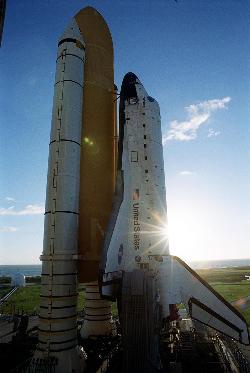 KENNEDY SPACE CENTER, Fla. -- Light from the morning sun glances off the back of Space Shuttle Discovery as it sits on Launch Pad 39A. On the horizon can be seen the Atlantic Ocean. Discovery is scheduled to launch Oct. 5 at 9:30 p.m. EDT on mission STS-92. Making the 100th Space Shuttle mission launched from Kennedy Space Center, Discovery will carry two pieces of hardware for the International Space Station, the Z1 truss, which is the cornerstone truss of the Station, and the third Pressurized Mating Adapter. Discovery also will be making its 28th flight into space, more than any of the other orbiters to date