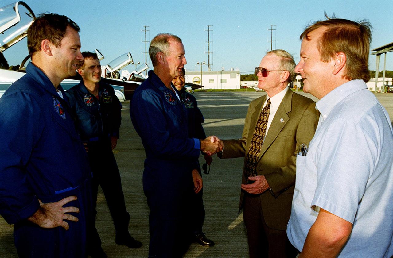 Center Director Roy Bridges greets STS-92 Commander Brian Duffy after the crew’s arrival at the KSC Shuttle Landing Facility. Behind Duffy are Mission Specialists Michael Lopez-Alegria, Jeff Wisoff and Koichi Wakata (NASDA). Next to Bridges is Michael Leinbach, the new KSC launch director. The STS-92 crew is at KSC to take part in Terminal Countdown Demonstration Test (TCDT) activities. The TCDT includes emergency egress training from the orbiter and pad, plus a simulated countdown. The fifth mission to the International Space Station, STS-92 will carry the Integrated Truss Structure Z1, the first of the planned 10 trusses on the Space Station, and the third Pressurized Mating Adapter. The Z1 will allow the first U.S. solar arrays on a future flight to be temporarily installed on Unity for early power. PMA-3 will provide a Shuttle docking port for the solar array installation on the sixth ISS flight and Lab installation on the seventh ISS flight. STS-92 is scheduled to launch Oct. 5 from launch Pad 39A. It will be the 100th flight in the Shuttle program