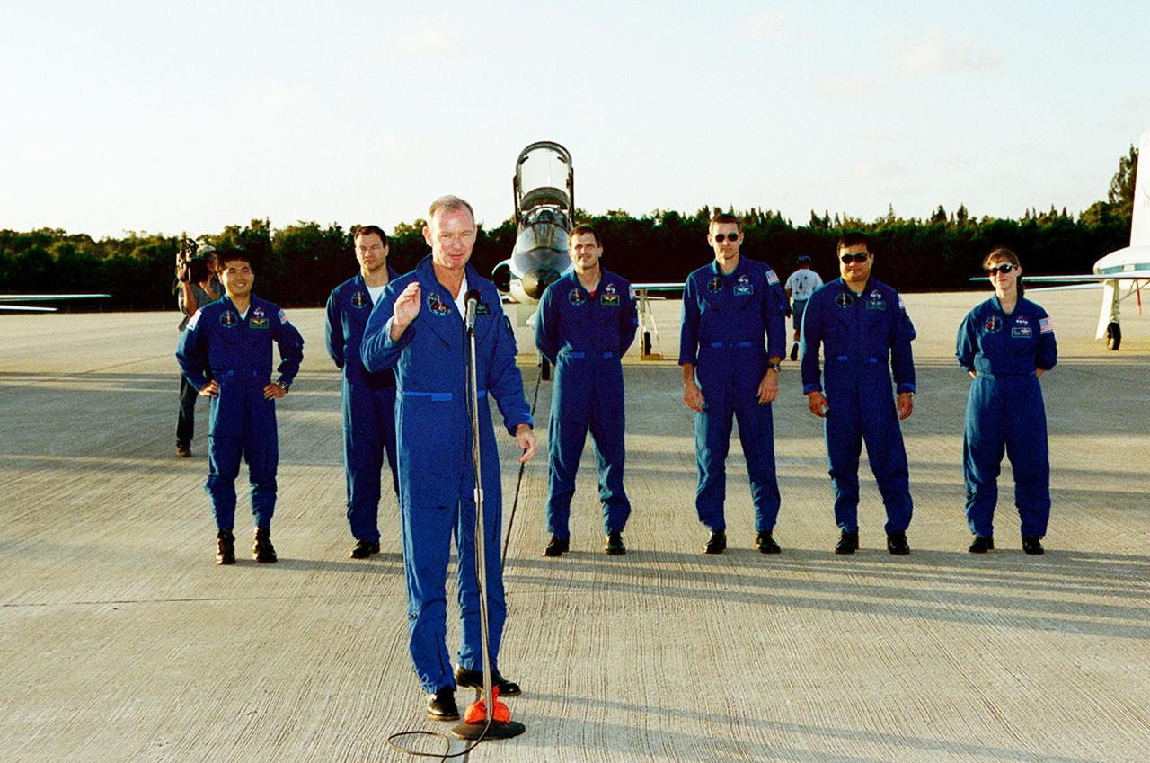 STS-92 Commander Brian Duffy, at the microphone, waves to the media after introducing the crew. Standing behind him are Mission Specialists Koichi Wakata, Michael Lopez-Alegria, Jeff Wisoff, Bill McArthur and Leroy Chiao; and Pilot Pam Melroy. The crew is at KSC to take part in Terminal Countdown Demonstration Test (TCDT) activities. The TCDT includes emergency egress training from the orbiter and pad, plus a simulated countdown. The fifth mission to the International Space Station, STS-92 will carry the Integrated Truss Structure Z1, the first of the planned 10 trusses on the Space Station, and the third Pressurized Mating Adapter. The Z1 will allow the first U.S. solar arrays on a future flight to be temporarily installed on Unity for early power. PMA-3 will provide a Shuttle docking port for the solar array installation on the sixth ISS flight and Lab installation on the seventh ISS flight. STS-92 is scheduled to launch Oct. 5 from launch Pad 39A. It will be the 100th flight in the Shuttle program