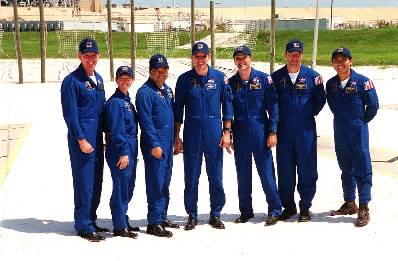 KENNEDY SPACE CENTER, FLA. -- At the slidewire basket area of Launch Pad 39A, the STS-92 crew poses for a group photograph after a question and answer session with the media. Standing left to right are Commander Brian Duffy, Pilot Pamela Ann Melroy and Mission Specialists Leroy Chiao, William S. McArthur Jr. (with microphone), Peter J.K. “Jeff” Wisoff, Michael E. Lopez-Alegria and Koichi Wakata of Japan. The crew is at KSC for Terminal Countdown Demonstration Test activities that provide emergency egress training, opportunities to inspect the mission payload, and take part in a simulated countdown. The slidewire basket area is a landing site for the crew if they have to use the slidewire baskets to exit the orbiter on the pad in an emergency. STS-92 is scheduled to launch Oct. 5 at 9:38 p.m. EDT on the fifth flight to the International Space Station. It will carry two elements of the Space Station, the Integrated Truss Structure Z1 and the third Pressurized Mating Adapter. The mission is also the 100th flight in the Shuttle program