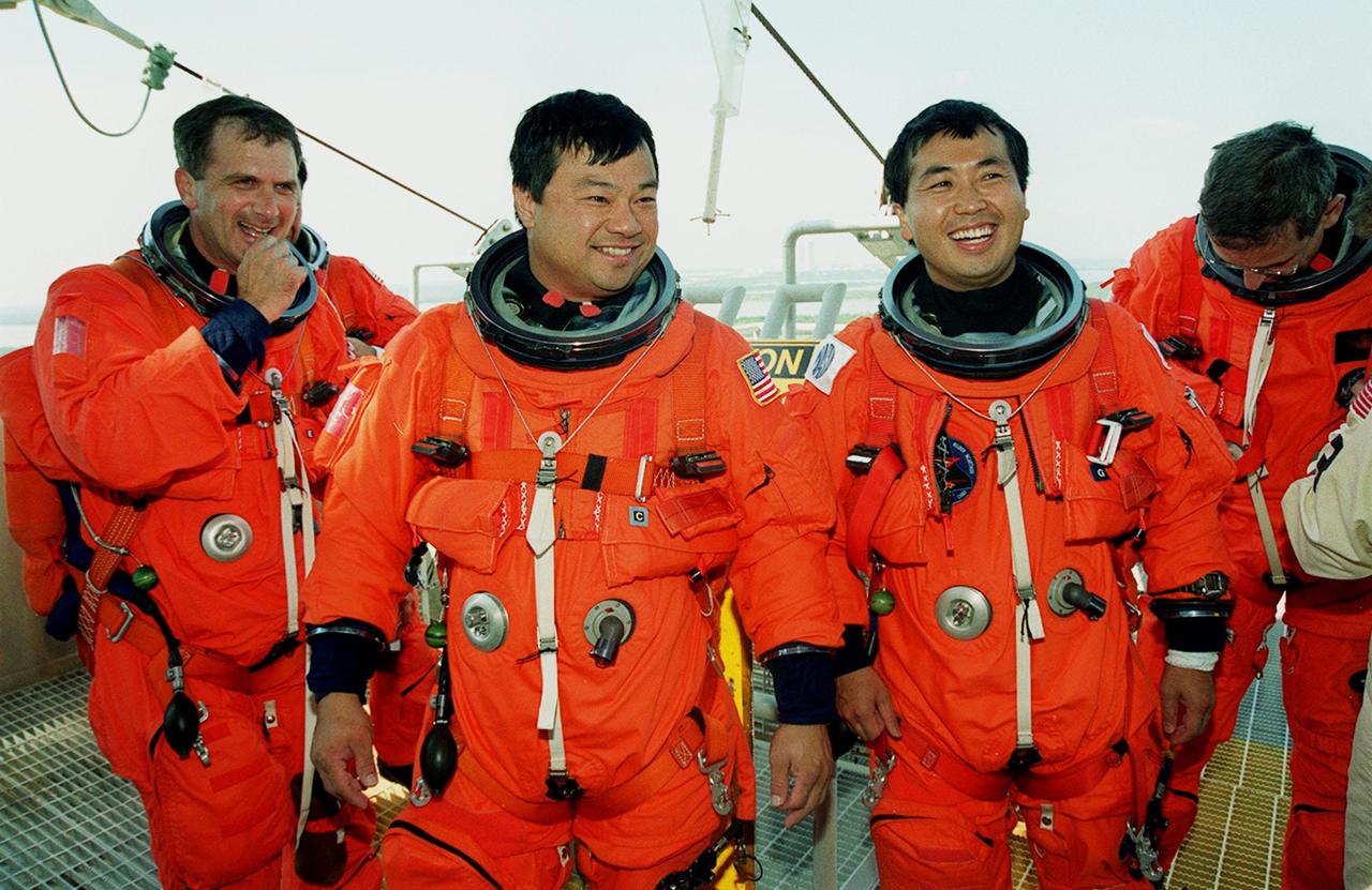 KENNEDY SPACE CENTER, FLA. -- STS-92 Mission Specialists (left to right) Peter J.K. “Jeff” Wisoff, Leroy Chiao, Koichi Wakata of Japan and William S. McArthur Jr. finish emergency egress training in the slidewire baskets behind them. The training is part of Terminal Countdown Demonstration Test activities that also include a simulated countdown. STS-92 is scheduled to launch Oct. 5 at 9:38 p.m. EDT on the fifth flight to the International Space Station. It will carry two elements of the Space Station, the Integrated Truss Structure Z1 and the third Pressurized Mating Adapter. The mission is also the 100th flight in the Shuttle program