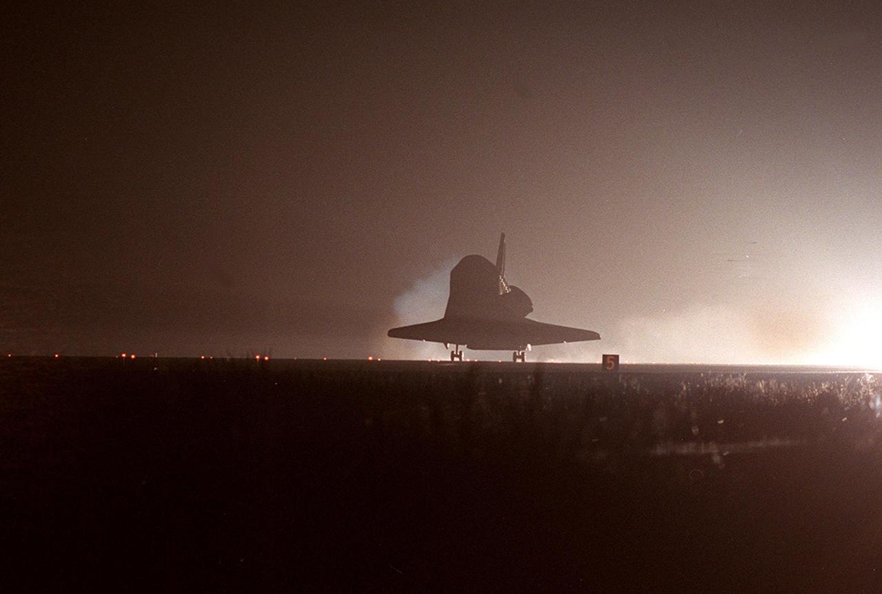 KENNEDY SPACE CENTER, Fla. -- Space Shuttle Atlantis appears ghostlike in the runway lights as it touches down on the KSC Shuttle Landing Facility Runway 15. At the controls are Commander Terrence W. Wilcutt and Pilot Scott D. Altman. Also on board the orbiter are Mission Specialists Edward T. Lu, Yuri I. Malenchenko, Boris V. Morukov, Richard A. Mastracchio and Daniel C. Burbank. Malenchenko and Morukov are with the Russian Aviation and Space Agency. Atlantis and crew traveled 4.9 million miles on the 11-day, 19-hour, 11-minute STS-106 mission. Main gear touchdown was at 3:56:48 a.m. EDT, landing on orbit 185 of the mission. Nose gear touchdown was at 3:56:57 a.m. EDT and wheel stop at 3:58:01 a.m. EDT. The crew has returned from the International Space Station where they transferred nearly 5,000 pounds of equipment and supplies for use by the first resident crew expected to arrive in November. This was the 99th flight in the Shuttle program and the 22nd for Atlantis. STS-106 also marked the 15th nighttime landing in Shuttle history and the 23rd consecutive landing at KSC