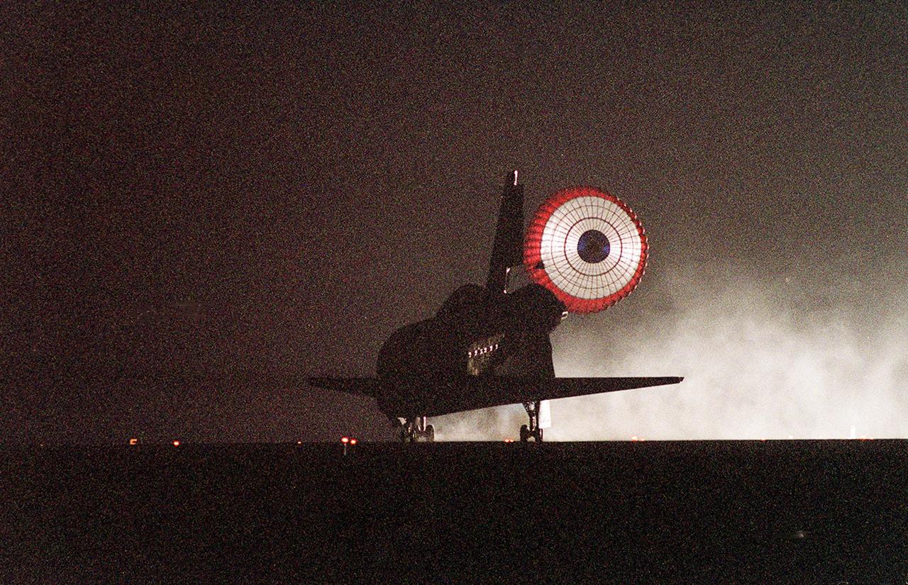 KENNEDY SPACE CENTER, Fla. -- Upon touchdown on Runway 15 of KSC’s Shuttle Landing Facility, Atlantis’s drag chute opens to help slow the vehicle. At the controls are Commander Terrence W. Wilcutt and Pilot Scott D. Altman. Also on board the orbiter are Mission Specialists Edward T. Lu, Yuri I. Malenchenko, Boris V. Morukov, Richard A. Mastracchio and Daniel C. Burbank. Malenchenko and Morukov are with the Russian Aviation and Space Agency. Atlantis and crew traveled 4.9 million miles on the 11-day, 19-hour, 11-minute STS-106 mission. Main gear touchdown was at 3:56:48 a.m. EDT, landing on orbit 185 of the mission. Nose gear touchdown was at 3:56:57 a.m. EDT and wheel stop at 3:58:01 a.m. EDT. The crew has returned from the International Space Station where they transferred nearly 5,000 pounds of equipment and supplies for use by the first resident crew expected to arrive in November. This was the 99th flight in the Shuttle program and the 22nd for Atlantis. STS-106 also marked the 15th nighttime landing in Shuttle history and the 23rd consecutive landing at KSC