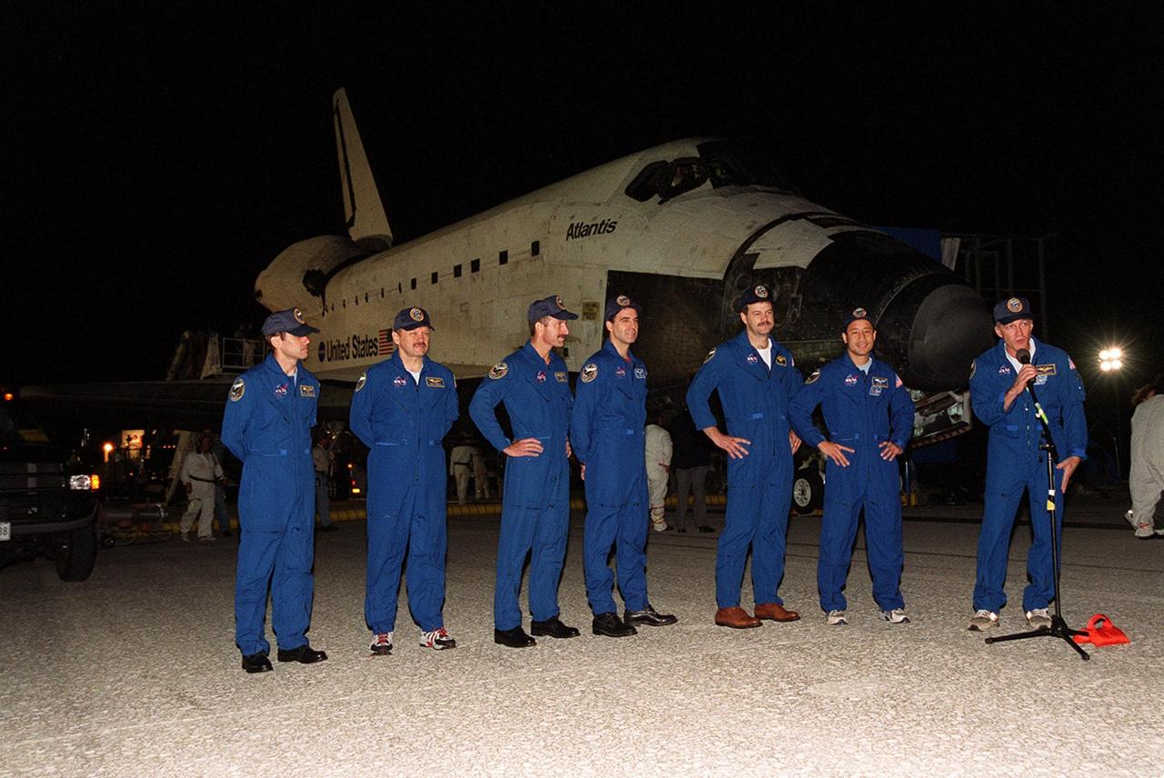 KENNEDY SPACE CENTER, FLA. -- Standing in front of the orbiter Atlantis after a successful landing at the Shuttle Landing Facility, the STS-106 crew greets the media and onlookers. Standing, left to right, are Mission Specialists Yuri I. Malenchenko, Boris V. Morukov, Daniel C. Burbank and Richard A. Mastracchio; Pilot Scott D. Altman; Mission Specialist Edward T. Lu; and Commander Terrence W. Wilcutt at the microphone. Main gear touchdown occurred on-time at 3:56:48 a.m. EDT.; Atlantis and crew traveled 4.9 million miles on the 11-day, 19-hour, 11-minute STS-106 mission. During the mission to the International Space Station, the crew transferred nearly 5,000 pounds of equipment and supplies for use by the first resident crew expected to arrive in November. STs-106 was the 99th flight in the Shuttle program and the 22nd for Atlantis. STS-106 also marked the 15th nighttime landing in Shuttle history and the 23rd consecutive landing at KSC