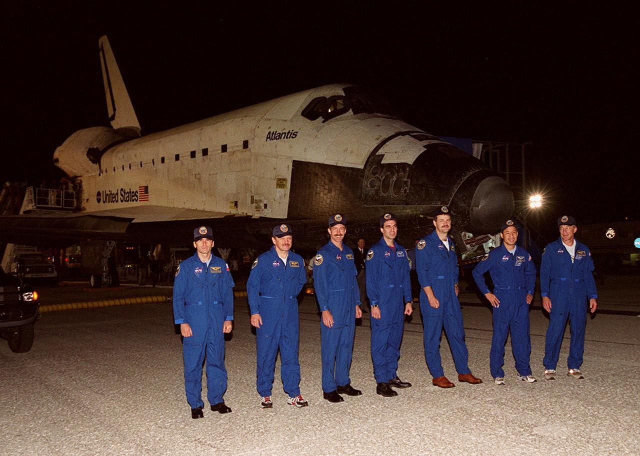 KENNEDY SPACE CENTER, FLA. -- The STS-106 crew poses for a photograph after a successful mission and landing. Standing, left to right, are Mission Specialists Yuri I. Malenchenko, Boris V. Morukov, Daniel C. Burbank and Richard A. Mastracchio; Pilot Scott D. Altman; Mission Specialist Edward T. Lu; and Commander Terrence W. Wilcutt.; Main gear touchdown occurred on-time at 3:56:48 a.m. EDT.; Atlantis and crew traveled 4.9 million miles on the 11-day, 19-hour, 11-minute STS-106 mission. During the mission to the International Space Station, the crew transferred nearly 5,000 pounds of equipment and supplies for use by the first resident crew expected to arrive in November. STS-106 was the 99th flight in the Shuttle program and the 22nd for Atlantis. STS-106 also marked the 15th nighttime landing in Shuttle history and the 23rd consecutive landing at KSC