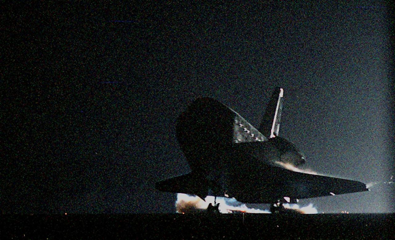 KENNEDY SPACE CENTER, Fla. -- Atlantis’ main gear touchdown on Runway 15 of the KSC Shuttle Landing Facility kicks up swirls of dust reflected in the runway lights. Atlantis and crew traveled 4.9 million miles on the 11-day, 19-hour, 11-minute mission STS-106. Main gear touchdown occurred on-time at 3:56:48 a.m. EDT. During the mission to the International Space Station, the crew transferred nearly 5,000 pounds of equipment and supplies for use by the first resident crew expected to arrive in November. STS-106 was the 99th flight in the Shuttle program and the 22nd for Atlantis. STS-106 also marked the 15th nighttime landing in Shuttle history and the 23rd consecutive landing at KSC
