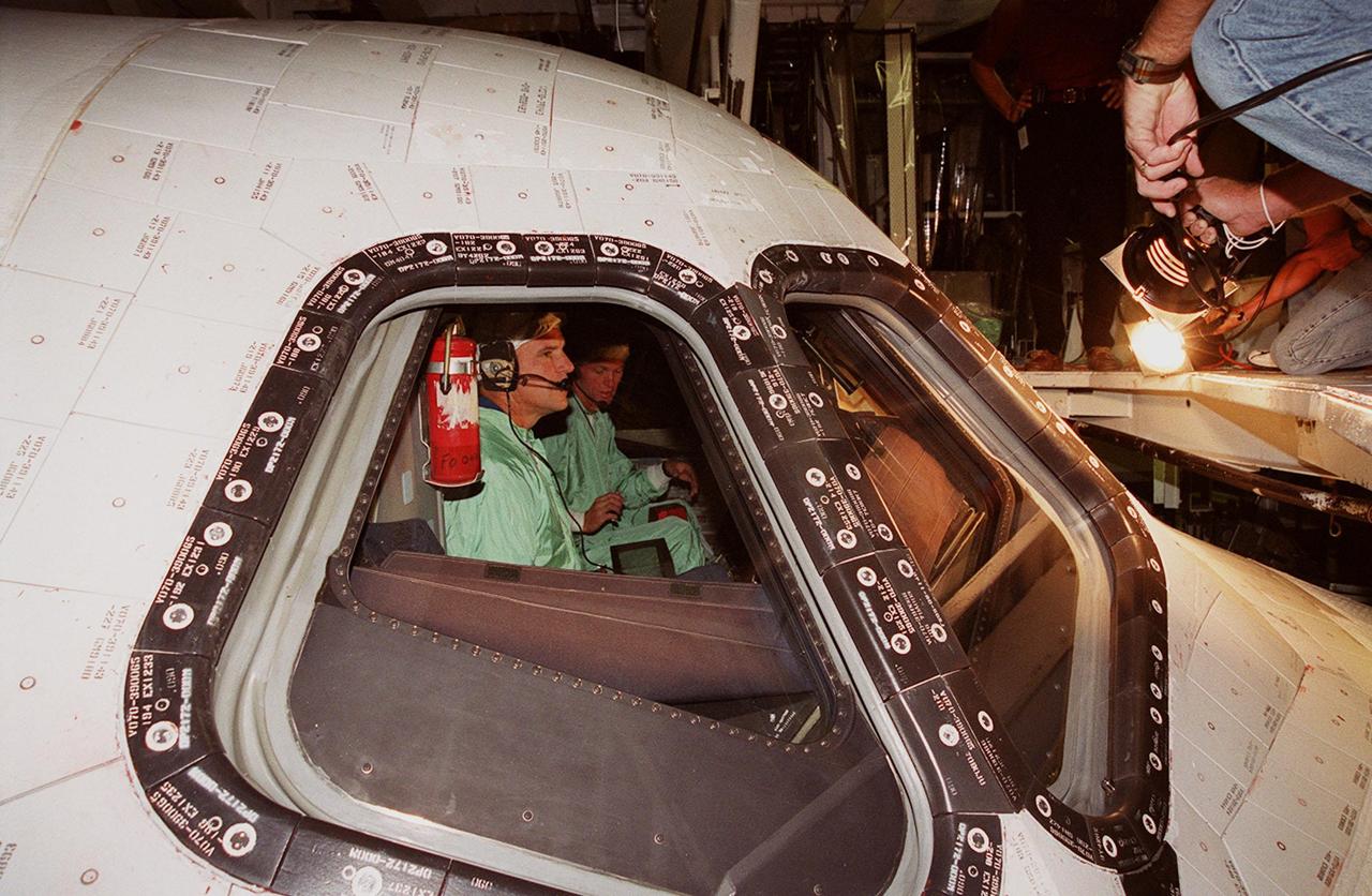 During a Crew Equipment Interface Test (CEIT), STS-97 Commander Brent Jett (left) and Pilot Michael Bloomfied (right) check out the cockpit of orbiter Endeavour in Orbiter Processing Facility bay 2 as part of preflight preparations. The CEIT provides an opportunity for crew members to check equipment and facilities that will be on board the orbiter during their mission. The STS-97 mission will be the sixth construction flight to the International Space Station. The payload includes a photovoltaic (PV) module, providing solar power to the Station. STS-97 is scheduled to launch Nov. 30 from KSC for the 10-day mission