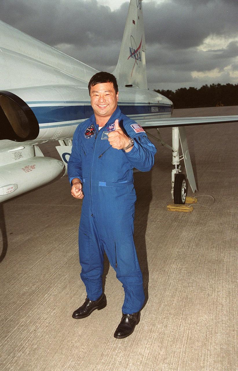 KENNEDY SPACE CENTER, FLA. -- STS-92 Mission Specialist Leroy Chiao gives a thumbs-up to his arrival at KSC for launch of Space Shuttle Discovery on Oct. 5. Chiao is standing next to the T-38 jet aircraft that brought him from Houston. He and other crew members Commander Brian Duffy, Pilot Pamela Ann Melroy and Mission Specialists Koichi Wakata of Japan, Peter J.K. “Jeff” Wisoff, Michael E. Lopez-Alegria and William S. McArthur Jr. expressed their eagerness to launch to a waiting group of media at the Shuttle Landing Facility. The mission is the fifth flight for the construction of the International Space Station. The payload includes the Integrated Truss Structure Z-1 and the third Pressurized Mating Adapter. During the 11-day mission, four extravehicular activities (EVAs), or space walks, are planned