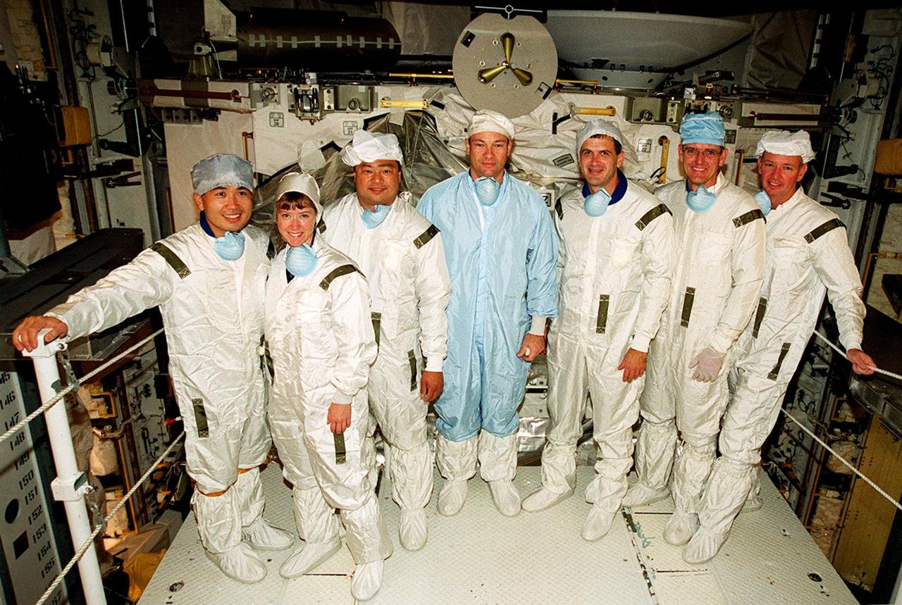 KENNEDY SPACE CENTER, FLA. -- The STS-92 crew poses for a group photo in front of the Integrated Truss Structure Z-1, part of the payload on their mission. From left, they are Mission Specialist Koichi Wakata of Japan; Pilot Pamela Ann Melroy; Mission Specialists Leroy Chiao, Michael E. Lopez-Alegria, Peter J.K. “Jeff” Wisoff and William S. McArthur Jr.; and Commander Brian Duffy. The crew has been inspecting the payload in preparation for launch Oct. 5, 2000. The mission is the fifth flight for the construction of the International Space Station. The payload also includes the third Pressurized Mating Adapter. During the 11-day mission, four extravehicular activities (EVAs), or space walks, are planned