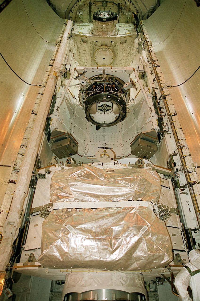 KENNEDY SPACE CENTER, FLA. -- The open doors of Space Shuttle Discovery’s payload bay show the two elements to be added to the International Space Station on mission STS-92. At top is the third Pressurized Mating Adapter; below it is Integrated Truss Structure Z-1, the cornerstone truss of the Station. Making the 100th Space Shuttle mission launched from Kennedy Space Center, Discovery also will be making its 28th flight into space. On the 11-day mission, the crew of seven will be making four space walks to attach the hardware to the Station. l Space Station. The payload also includes the Integrated Truss Structure Z-1. During the 11-day mission, four extravehicular activities (EVAs), or space walks, are planned
