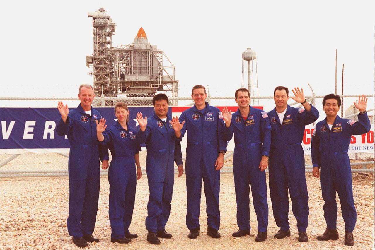 KENNEDY SPACE CENTER, Fla. --  The STS-92 crew happily wave to onlookers as they gather gather outside the gate to Launch Pad 39A where Space Shuttle Discovery waits in the background for liftoff Oct. 5 at 9:38 p.m. EDT. From left to right are Commander Brian Duffy, Pilot Pamela Ann Melroy, and Mission Specialists Leroy Chiao, William S. McArthur Jr., Peter J.K. “Jeff” Wisoff, Michael E. Lopez-Alegria and Koichi Wakata of Japan. The mission payload includes Integrated Truss Structure Z-1, an early exterior framework to allow the first U.S. solar arrays on a future flight to be temporarily installed on Unity for early power; Ku-band communication to support early science capability and U.S. television; and the third Pressurized Mating Adapter to provide a Shuttle docking port for solar array installation on the sixth ISS flight and Lab installation on the seventh ISS flight. The 11-day mission will include four spacewalks. stallation on the sixth ISS flight and Lab installation on the seventh ISS flight. The 11-day mission will include four spacewalks