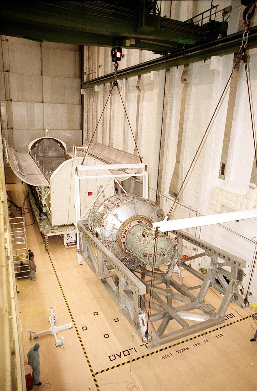 KENNEDY SPACE CENTER, FLA. -- In the Operations and Checkout Building, the Joint Airlock Module is placed in a horizontal position to be transferred to the payload canister behind it. Then it will be moved to the Space Station Processing Facility where it will continue to undergo preflight processing for the STS-104 mission scheduled for launch aboard Space Shuttle Atlantis May 17, 2001. The Joint Airlock Module is the gateway from which crew members aboard the International Space Station will enter and exit the 470-ton orbiting research facility