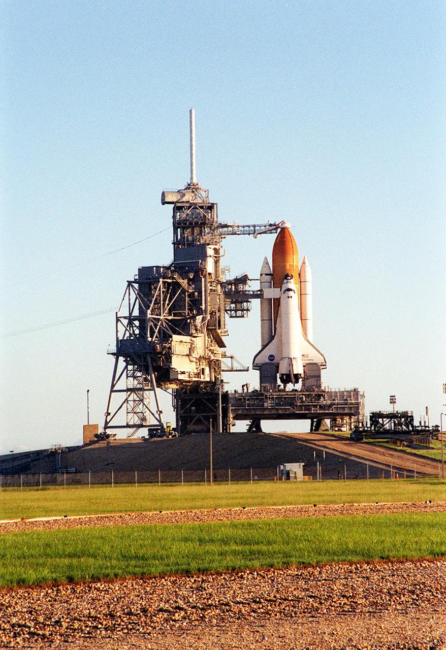 KENNEDY SPACE CENTER, Fla. --  An early morning shot of the Space Shuttle Discovery on the Mobile Launcher Platform and Launch Pad 39A. Discovery is being readied for the STS-92 mission launch to the International Space Station (ISS). At the top is the 13-foot-wide “beanie cap,” at the end of the Gaseous Oxygen Vent Arm, designed to vent gaseous oxygen vapors away from the Space Shuttle. Lower is the Orbiter Access Arm with the environmental chamber, known as the “white room,” extended to the orbiter. The chamber provides entry for the crew into the orbiter and also serves as emergency egress up to 7 minutes 24 seconds before launch. The STS-92 mission payload includes Integrated Truss Structure Z-1, an early exterior framework to allow the first U.S. solar arrays on a future flight to be temporarily installed on Unity for early power; Ku-band communication to support early science capability and U.S. television; and the third Pressurized Mating Adapter to provide a Shuttle docking port for solar array installation on the sixth ISS flight and Lab installation on the seventh ISS flight. The 11-day mission will include four spacewalks. Liftoff is scheduled for Oct. 6 at 9:16 p.m. EDT
