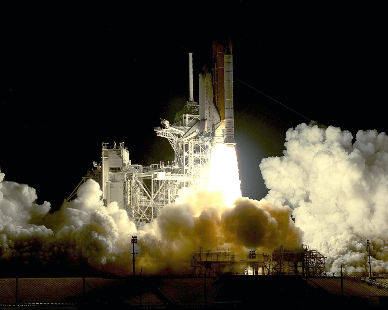 KENNEDY SPACE CENTER, Fla. -- Billows of smoke and steam spread across Launch Pad 39A as Space Shuttle Discovery lifts off on mission STS-92 to the International Space Station. The perfect on-time liftoff occurred at 7:17 p.m. EDT, sending a crew of seven on the 100th launch in the history of the Shuttle program. Discovery carries a payload that includes the Integrated Truss Structure Z-1, first of 10 trusses that will form the backbone of the Space Station, and the third Pressurized Mating Adapter that will provide a Shuttle docking port for solar array installation on the sixth Station flight and Lab installation on the seventh Station flight. Discovery’s landing is expected Oct. 22 at 2:10 p.m. EDT