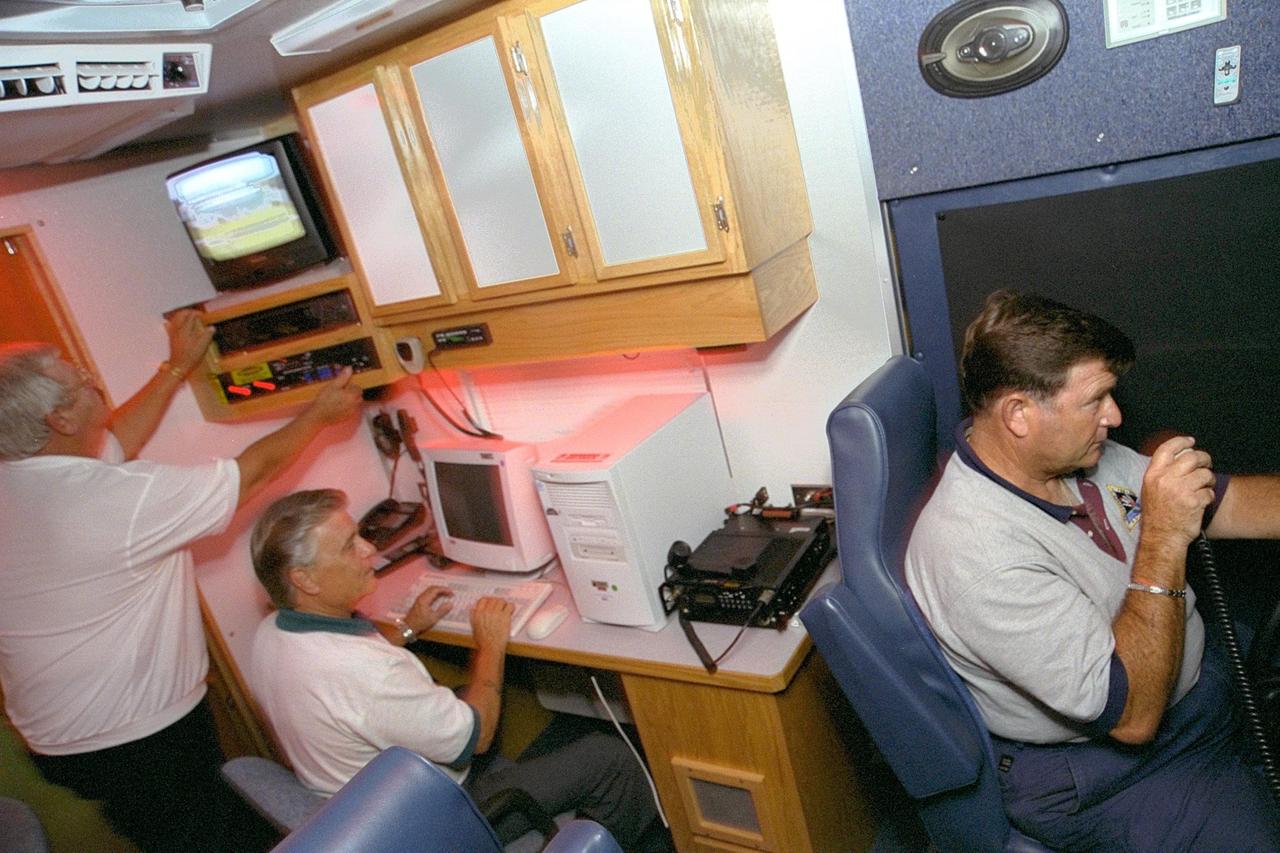 Robert ZiBerna, Roger Scheidt and Charles Street, the Emergency Preparedness team at KSC, practice for an emergency scenario inside the Mobile Command Center, a specially equipped vehicle. It features a conference room, computer work stations, mobile telephones and a fax machine. It also can generate power with its onboard generator. Besides being ready to respond in case of emergencies during launches, the vehicle must be ready to help address fires, security threats, chemical spills, terrorist attaches, weather damage or other critical situations that might face KSC or Cape Canaveral Air Force Station