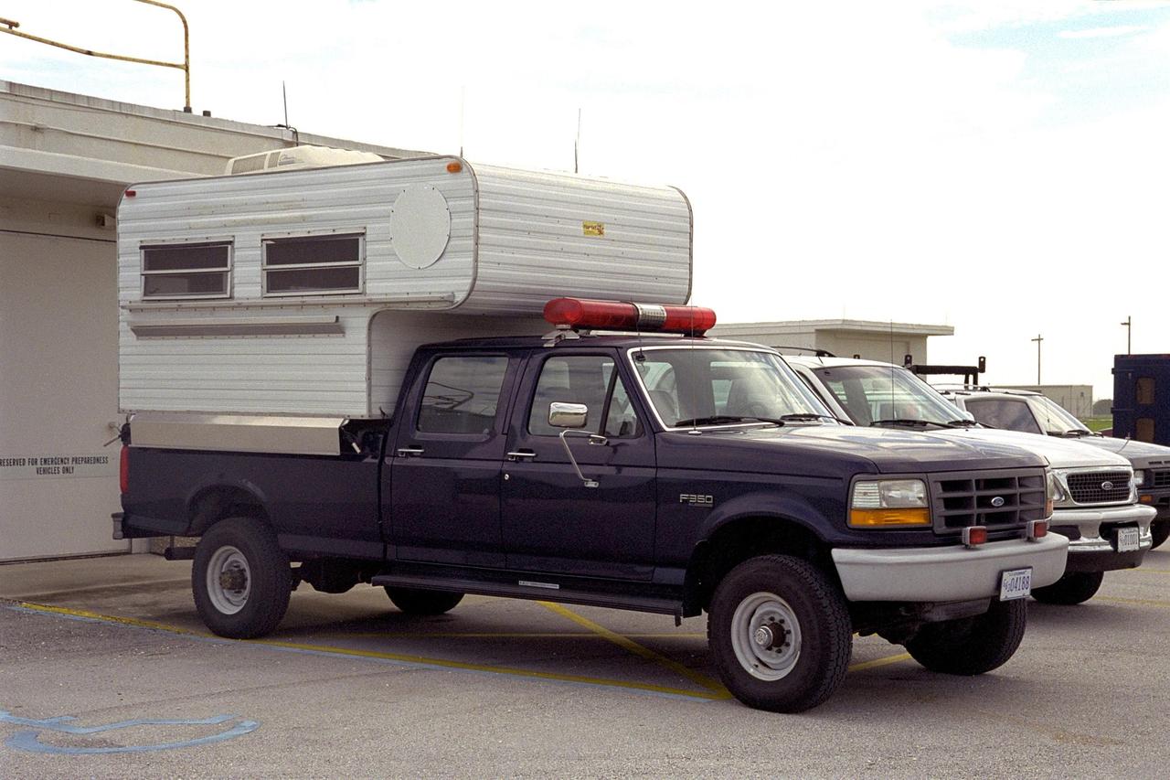 This camper-equipped truck known as “Old Blue” served as mobile field command center for the Emergency Preparedness team at KSC. It has been replaced with a larger vehicle that includes a conference room, computer work stations, mobile telephones and a fax machine, plus its own onboard generator. Besides being ready to respond in case of emergencies during launches, the vehicle must be ready to help address fires, security threats, chemical spills, terrorist attaches, weather damage or other critical situations that might face KSC or Cape Canaveral Air Force Station