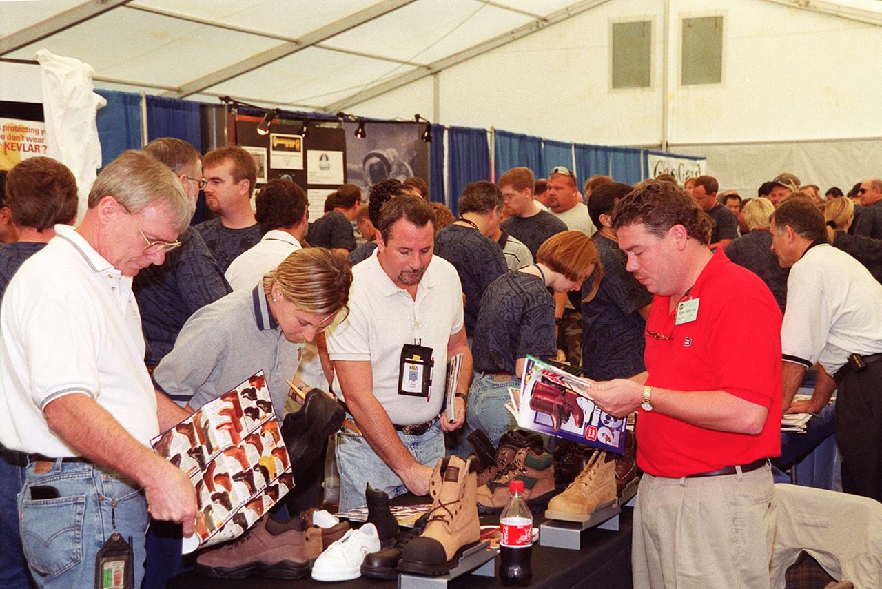 Employees at KSC look over a display of work-related shoes in an exhibit tent during Super Safety and Health Day. Safety Day is a full day of NASA-sponsored, KSC and 45th Space Wing events involving a number of health and safety related activities: Displays, vendors, technical paper sessions, panel discussions, a keynote speaker, etc. The entire Center and Wing stand down to participate in the planned events. Safety Day is held annually to proactively increase awareness in safety and health among the government and contractor workforce population. The first guiding principle at KSC is “Safety and Health First.” KSC’s number one goal is to “Assure sound, safe and efficient practices and processes are in place for privatized/commercialized launch site processing.