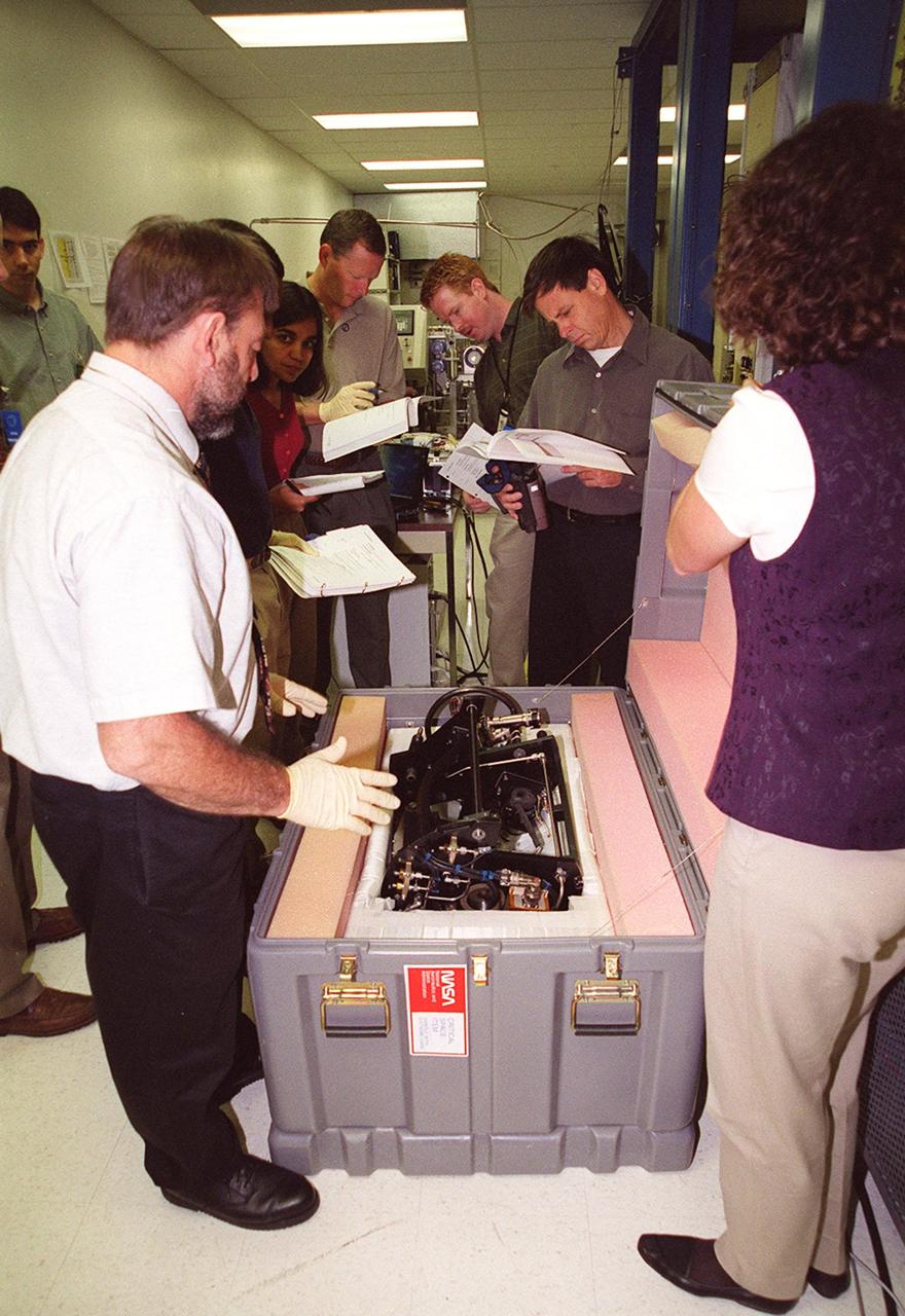 KENNEDY SPACE CENTER, FLA. -- STS-107 crew members check out equipment at SPACEHAB that will be part of their mission. In the background center can be seen Mission Specialists Kalpana Chawla and David Brown. At right are Mission Specialists Ilan Ramon and Laurel Clark. Identified as a research mission, STS-107 is scheduled for launch July 19, 2001