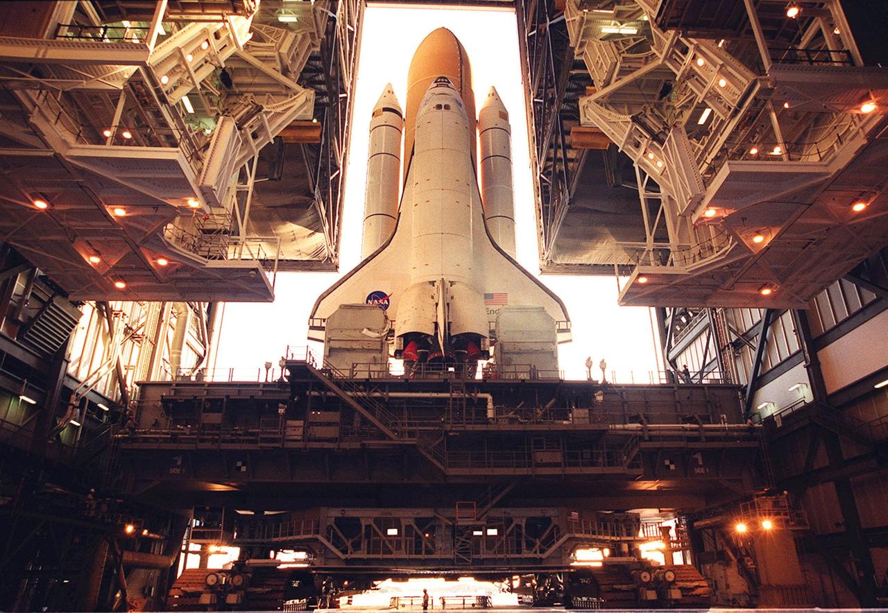 KENNEDY SPACE CENTER, Fla. -- Space Shuttle Endeavour appears dwarfed by the structures inside the Vehicle Assembly Building as it begins rollout to Launch Pad 39B. The Shuttle rests on top of the Mobile Launcher Platform (MLP). Underneath (bottom of photo) is the crawler-transporter that will move the Shuttle and MLP to the pad on four double-tracked crawlers. The maximum speed of the loaded transporter is 1 mph. Endeavour is scheduled to be launched Nov. 30 at 10:01 p.m. EST on mission STS-97, the sixth construction flight to the International Space Station. Its payload includes the P6 Integrated Truss Structure and a photovoltaic (PV) module, with giant solar arrays that will provide power to the Station. The mission includes two spacewalks to complete the solar array connections