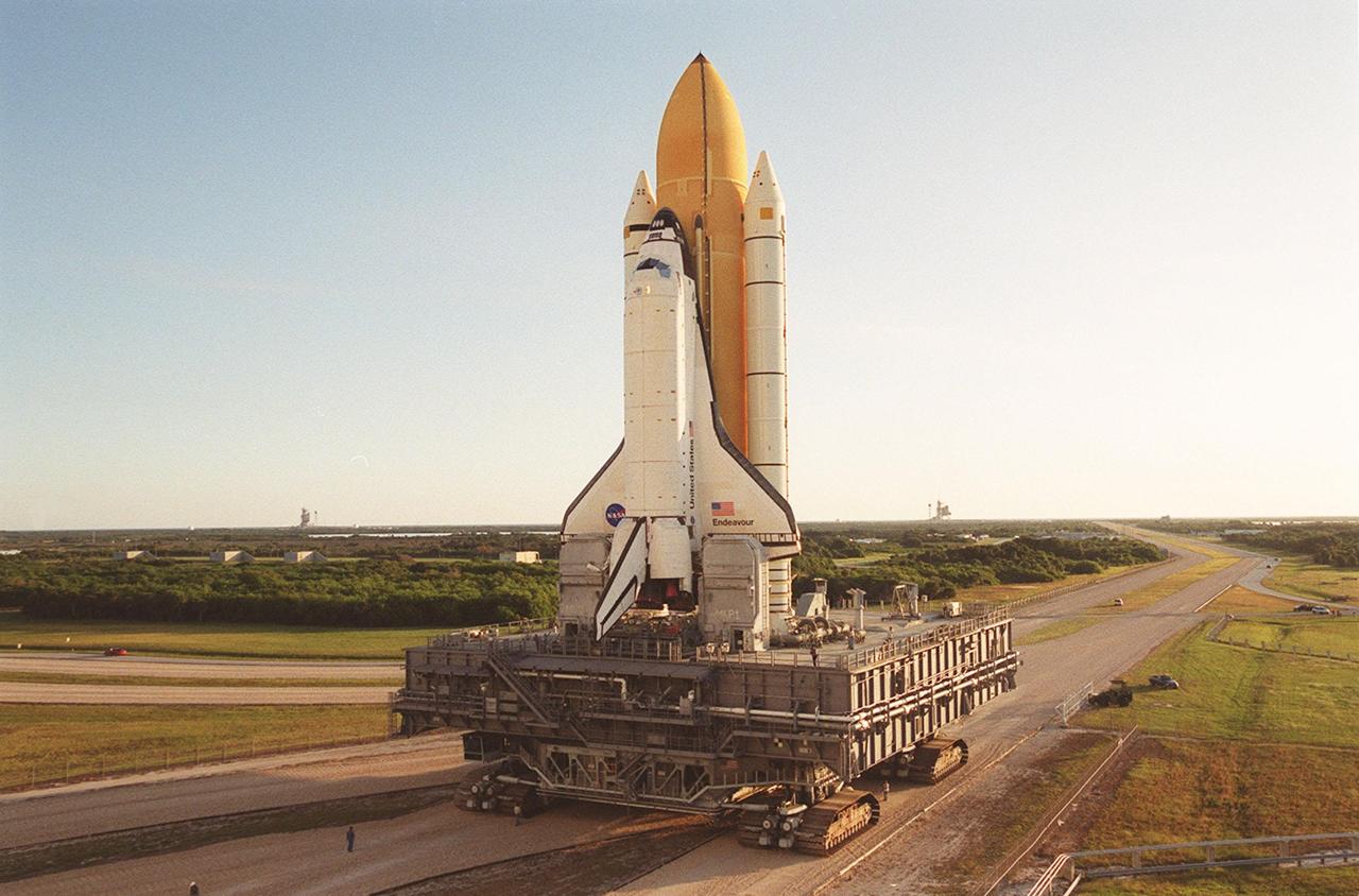 KENNEDY SPACE CENTER, Fla. -- Space Shuttle Endeavour inches its way to Launch Pad 39B via the crawlerway that leads from the Vehicle Assembly Building. The Shuttle is on the Mobile Launcher Platform (MLP) which is atop the crawler-transporter, moving on four double-tracked crawlers. The maximum speed of the loaded transporter is 1 mph. To the left and right of the Space Shuttle can be seen both launch pads, 39B and 39A respectively. Endeavour is scheduled to be launched Nov. 30 at 10:01 p.m. EST on mission STS-97, the sixth construction flight to the International Space Station. Its payload includes the P6 Integrated Truss Structure and a photovoltaic (PV) module, with giant solar arrays that will provide power to the Station. The mission includes two spacewalks to complete the solar array connections