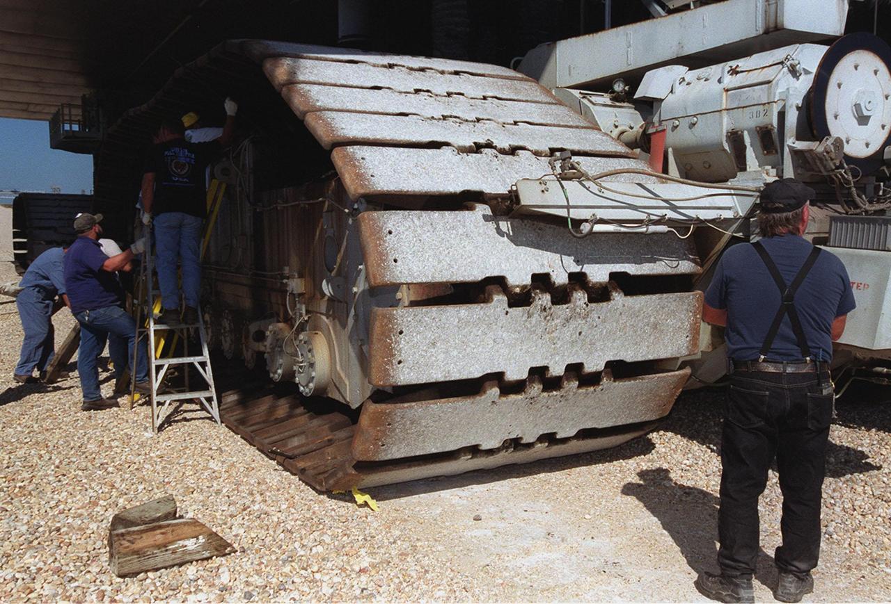 KENNEDY SPACE CENTER, FLA. -- A repair crew begin working on replacing a broken cleat on this track of the crawler-transporter. The crack was noticed as the crawler-transporter was moving Space Shuttle Endeavour to Launch Pad 39B. Rollout was delayed until the cleat could be replaced. The Space Shuttle was hard down on the pad several hours later. Endeavour is scheduled to be launched Nov. 30 at 10:01 p.m. EST on mission STS-97, the sixth construction flight to the International Space Station. Its payload includes the P6 Integrated Truss Structure and a photovoltaic (PV) module, with giant solar arrays that will provide power to the Station. The mission includes two spacewalks to complete the solar array connections