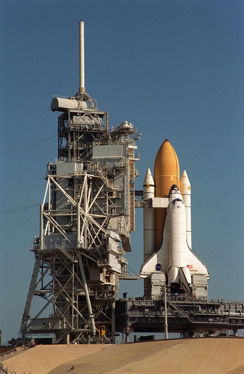 KENNEDY SPACE CENTER, FLA. -- Space Shuttle Endeavour finally rests on Launch Pad 39B after its rollout was delayed several hours to fix a broken cleat on the crawler-transporter. At the far left is the Rotating Service Structure. From the Fixed Service Structure, the Orbiter Access Arm is already extended to the orbiter. Endeavour is scheduled to be launched Nov. 30 at 10:01 p.m. EST on mission STS-97, the sixth construction flight to the International Space Station. Its payload includes the P6 Integrated Truss Structure and a photovoltaic (PV) module, with giant solar arrays that will provide power to the Station. The mission includes two spacewalks to complete the solar array connections