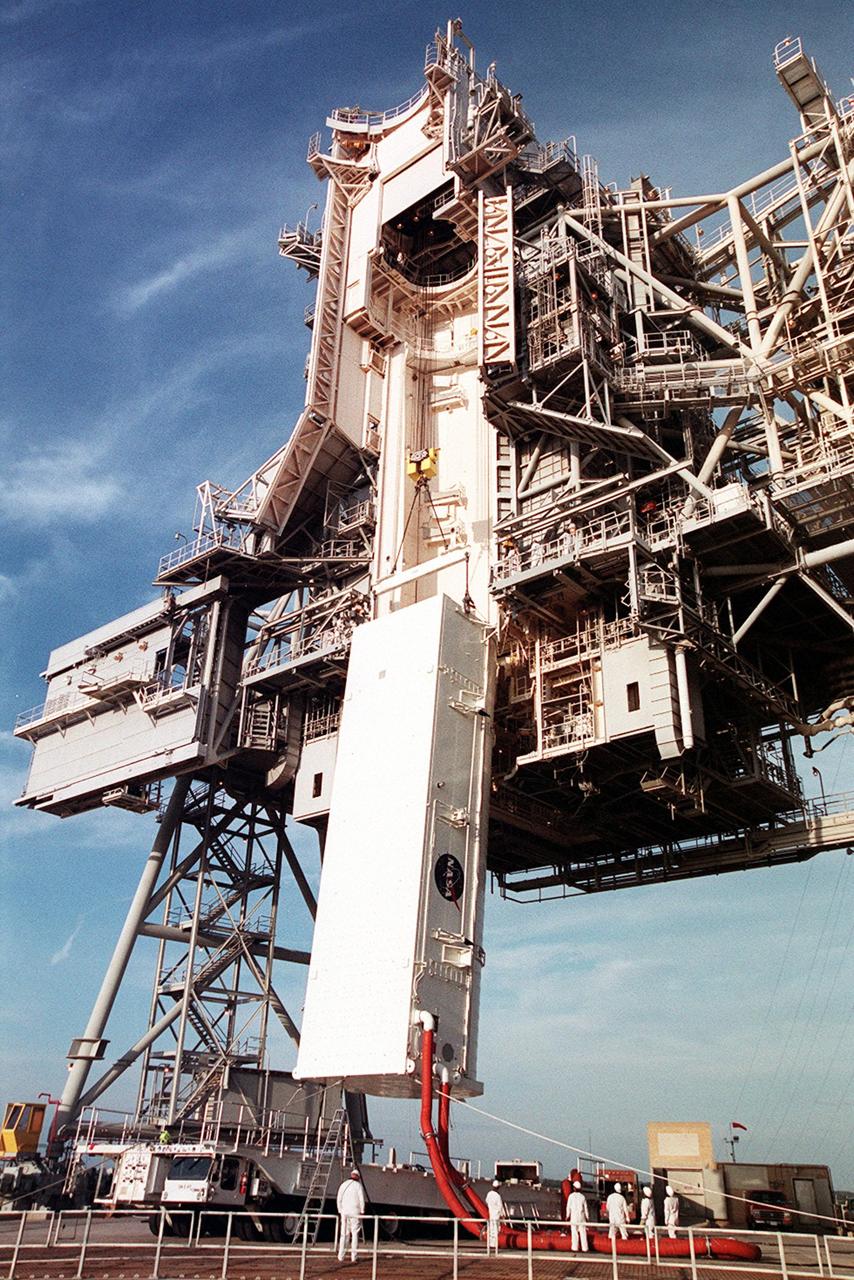 KENNEDY SPACE CENTER, FLA. -- On Launch Pad 39B, the payload transport canister, with the P6 integrated truss segment inside, is lifted toward the payload changeout room (PCR). The PCR is the enclosed, environmentally controlled portion of the Rotating Service Structure that supports payload delivery at the pad and subsequent vertical installation in the orbiter payload bay. Attached to the canister are the red umbilical lines that maintain the controlled environment inside. The P6, payload on mission STS-97, comprises Solar Array Wing-3 and the Integrated Electronic Assembly, to be installed on the International Space Station. The Station’s electrical power system will use eight photovoltaic solar arrays, each 112 feet long by 39 feet wide, to convert sunlight to electricity. The solar arrays are mounted on a “blanket” that can be folded like an accordion for delivery. Once in orbit, astronauts will deploy the blankets to their full size. Gimbals will be used to rotate the arrays so that they will face the Sun to provide maximum power to the Space Station. Launch of STS-97 is scheduled for Nov. 30 at 10:06 p.m. EST