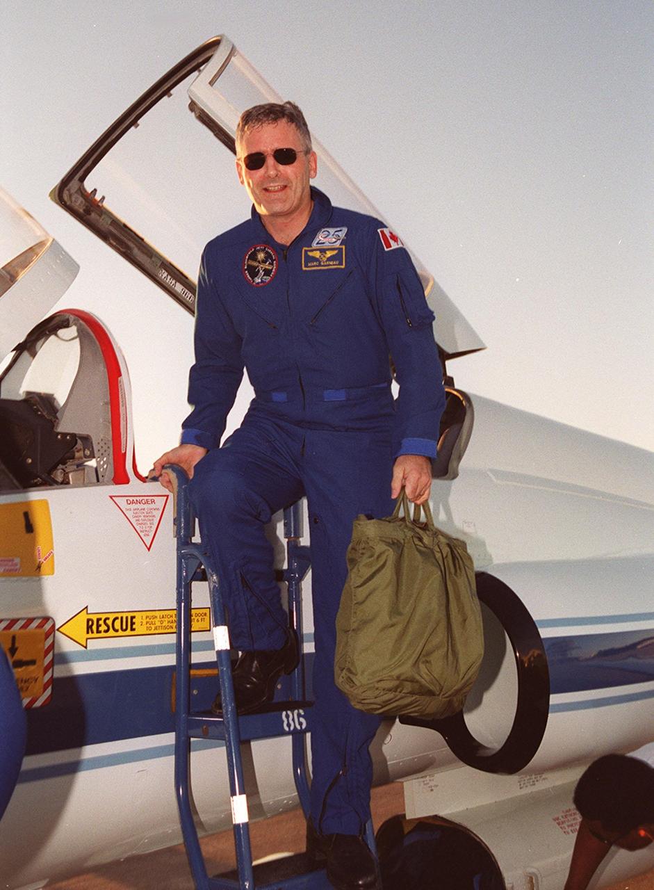 At the Shuttle Landing Facility, STS-97 Mission Specialist Marc Garneau, who is with the Canadian Space Agency, climbs down from a T-38 jet aircraft that brought him to KSC from Johnson Space Center. He and the rest of the crew have returned to KSC for the launch, scheduled for Nov. 30 at about 10:06 p.m. EST. Mission STS-97is the sixth construction flight to the International Space Station. Its payload includes the P6 Integrated Truss Structure and a photovoltaic (PV) module, with giant solar arrays that will provide power to the Station. The mission includes two spacewalks to complete the solar array connections. STS-97 is scheduled to launch Nov. 30 at about 10:06 p.m. EST