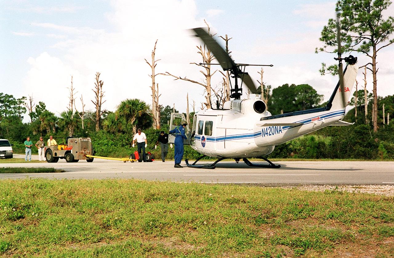 KENNEDY SPACE CENTER, FLA. -- A NASA helicopter lands on S.R. 3 for transfer to Patrick Air Force Base. It is one of four UH-1H helicopters that will have its blades painted, changing the black to a pattern of white and yellow stripes. The pattern provides better visibility in smoke and fire conditions. When the rotors are turning, the stripes create a yellow and white circle that is more easily seen by a second helicopter from above. The helicopters, primarily used for security and medical evacuation for NASA, will be used to deliver water via buckets during brush fires. The change was made to comply with U.S. Fish and Wildlife and Department of Forestry regulations for helicopter-assisted fire control
