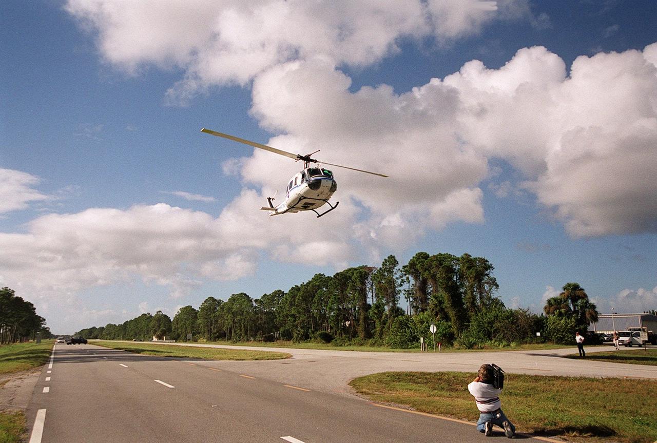 KENNEDY SPACE CENTER, FLA. -- At S.R. 3 a NASA helicopter returns to Patrick Air Force Base. The helicopter is one of four UH-1H helicopters that have had its blades painted, changing the previous black color to a pattern of white and yellow stripes. The pattern provides better visibility in smoke and fire conditions. When the rotors are turning, the stripes create a yellow and white circle that is more easily seen by a second helicopter from above. The helicopters, primarily used for security and medical evacuation for NASA, will be used to deliver water via buckets during brush fires. The change was made to comply with U.S. Fish and Wildlife and Department of Forestry regulations for helicopter-assisted fire control