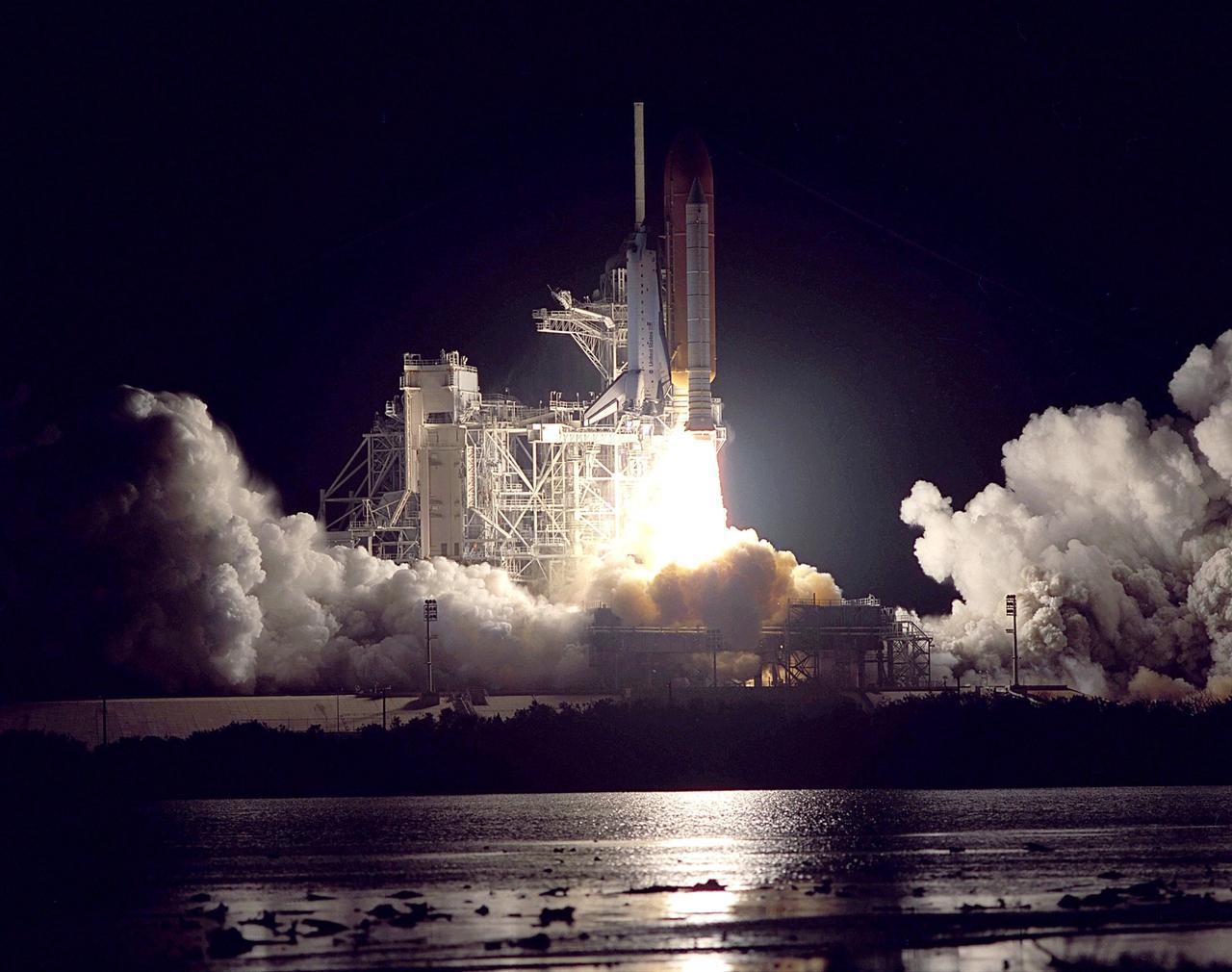 KENNEDY SPACE CENTER, Fla.  --  Clouds of smoke and steam roll across Launch Pad 39B and the nearby marshes as Space Shuttle Endeavour roars into the night sky in a perfect launch. Liftoff occurred on time at 10:06:01 p.m. EST. The Shuttle and its five-member crew will deliver U.S. solar arrays to the International Space Station and be the first Shuttle crew to visit the Station’s first resident crew. The 11-day mission includes three spacewalks. This marks the 101st mission in Space Shuttle history and the 25th night launch. Endeavour is expected to land Dec. 11 at 6:19 p.m. EST