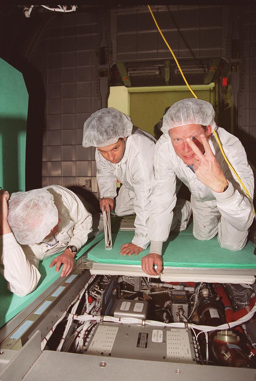 KENNEDY SPACE CENTER, Fla. -- STS-107 crew members take part in In-Flight Maintenance training for their mission. Under the watchful eyes of SPACEHAB trainer David Butler (left), Payload Specialist Ilan Ramon of Israel (center) and Mission Specialist David M. Brown (right) check equipment and paperwork inside the SPACEHAB Double Module. Research mission STS-107, scheduled to launch July 19, 2001, will carry the SPACEHAB Double Module in its first flight into space and a broad collection of experiments ranging from material science to life science