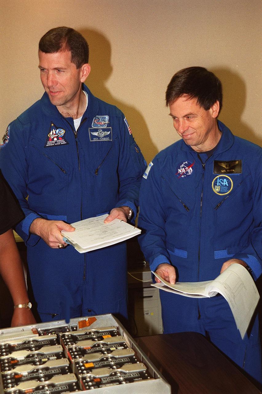 KENNEDY SPACE CENTER, FLA. -- As part of In-Flight Maintenance training at SPACEHAB, in Cape Canaveral, Fla., the STS-107 crew learns about Biological Research in Canisters (BRIC) experiments that will be on their mission. Seen looking over paperwork and one of the BRIC experiments are Commander Rick D. Husband (left) and Payload Specialist Ilan Ramon of Israel. STS-107 will carry a broad collection of experiments ranging from material science to life science. It is scheduled to launch July 19, 2001