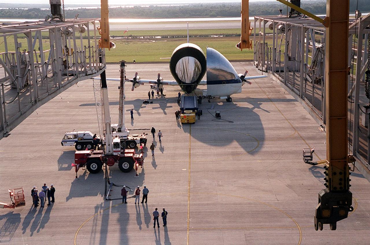 On the parking apron of the KSC Shuttle Landing Facility, near the Mate/Demate device (seen in the foreground), the opened nose of the Super Guppy aircraft reveals its cargo, the Integrated Truss Structure S3. It was built by The Boeing Co. After offloading, the S3 will be transported to the Operations and Checkout Building. The second starboard truss segment of the International Space Station, the S3 truss is scheduled to be added to the Station in April 2003