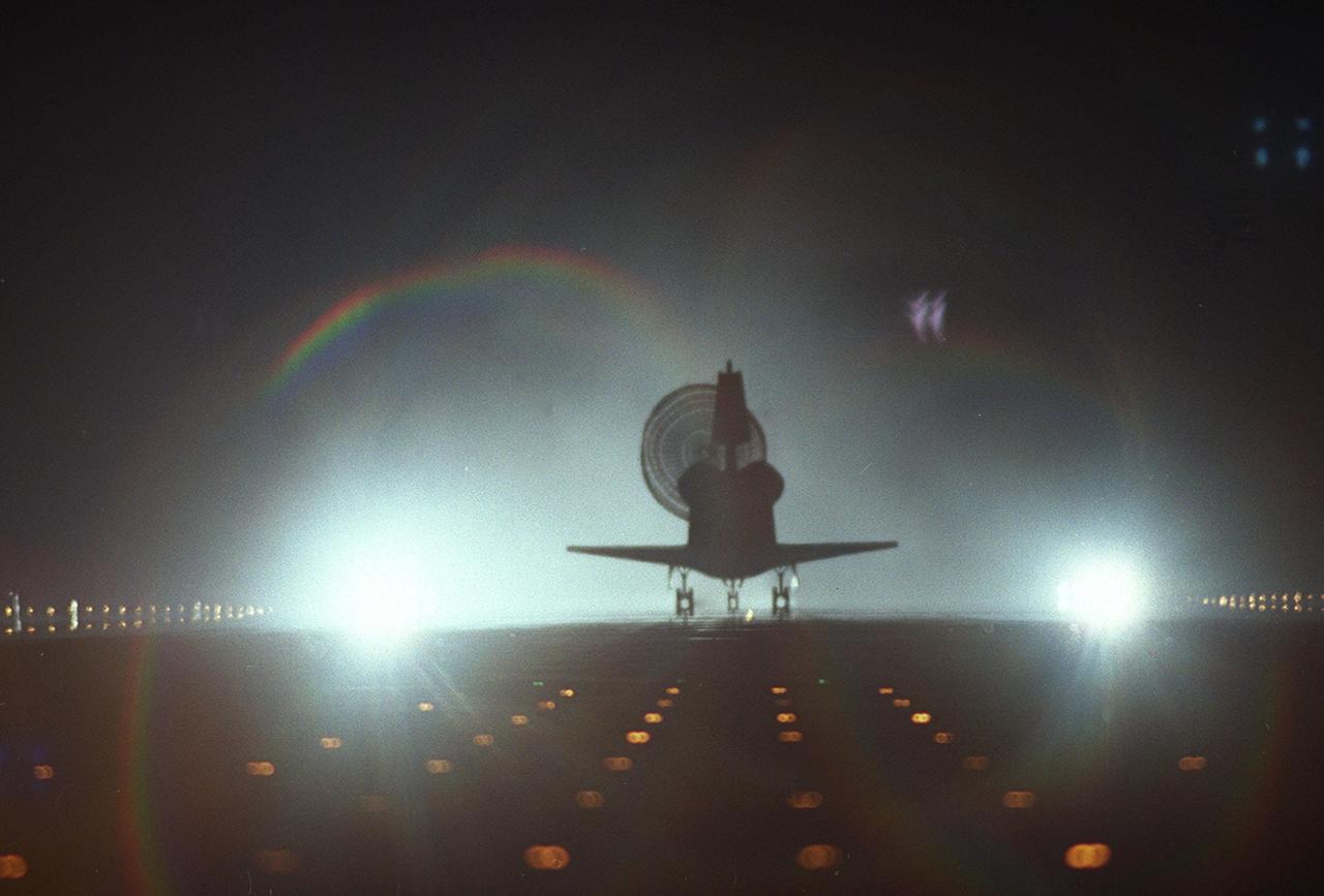 KENNEDY SPACE CENTER, Fla. -- Lights on Runway 15 silhouette Endeavour with its drag chute open as it lands at 6:04 p.m. EST following a 4.4-million-mile mission to the International Space Station. At the controls is Commander Brent Jett, completing the successful 10-day, 19-hour and 58-minute-long STS-97 mission. Other crew members on board are Pilot Michael Bloomfield and Mission Specialists Joseph Tanner, Carlos Noriega and Marc Garneau, with the Canadian Space Agency. Endeavour carried the P6 Integrated Truss Structure with solar arrays to power the International Space Station. The arrays and other equipment were installed during three EVAs that totaled 19 hours, 20 minutes. Endeavour was docked with the Space Station for 6 days, 23 hours, 13 minutes. This was the 16th nighttime landing for a Space Shuttle and the 53rd at Kennedy Space Center