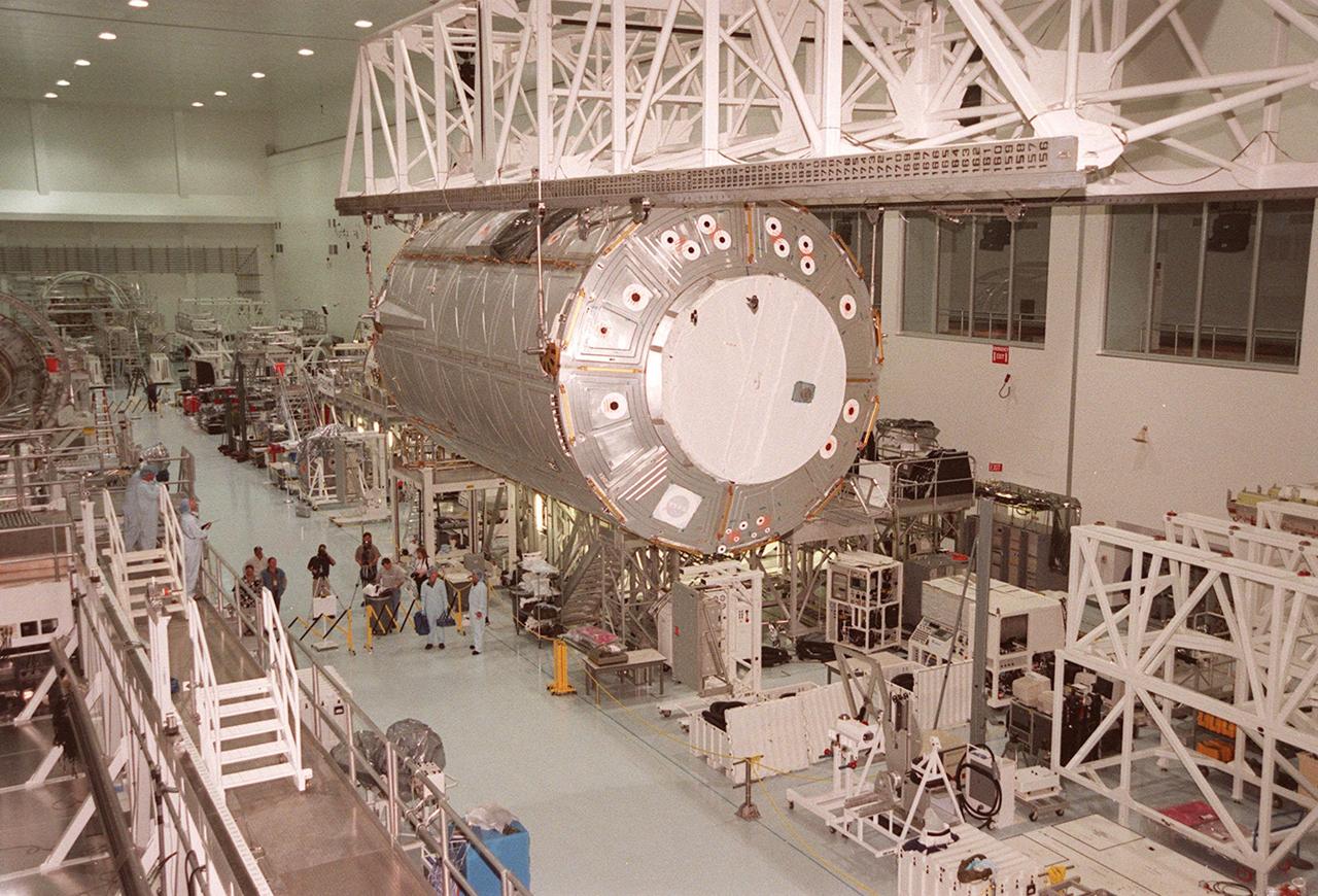 KENNEDY SPACE CENTER, FLA. -- The U.S. Laboratory Destiny travels past the Multi-Purpose Logistics Module Leonardo in its overhead passage down the Space Station Processing Facility. The lab is being moved to the Launch Package Integration Stand (LPIS) for a weight and center of gravity determination. Destiny is the payload aboard Space Shuttle Atlantis on mission STS-98 to the Space Station. The lab is fitted with five system racks and will already have experiments installed inside for the flight. The launch is scheduled for January 2001