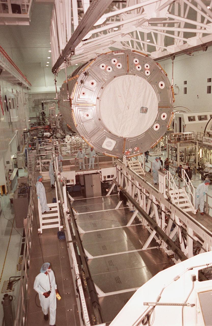 KENNEDY SPACE CENTER, FLA. -- In the Space Station Processing Facility, the U.S. Lab Destiny is lowered toward the Launch Package Integration Stand (LPIS) for a weight and center of gravity determination. Destiny is the payload aboard Space Shuttle Atlantis on mission STS-98 to the Space Station. The lab is fitted with five system racks and will already have experiments installed inside for the flight. The launch is scheduled for January 2001