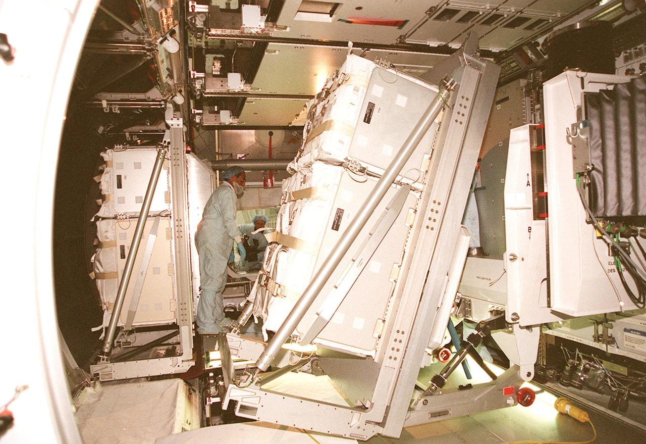 KENNEDY SPACE CENTER, FLA. -- Workers inside the Multi-Purpose Logistics Module Leonardo oversee installation of a laboratory rack. The MPLM is the first of three such pressurized modules that will serve as the International Space Station’s “moving vans,” carrying laboratory racks filled with equipment, experiments and supplies to and from the Space Station aboard the Space Shuttle. Leonardo will be launched March 1, 2001, on Shuttle mission STS-102 On that flight, Leonardo will be filled with equipment and supplies to outfit the U.S. laboratory module, being carried to the ISS on the Jan. 19, 2001, launch of STS-98