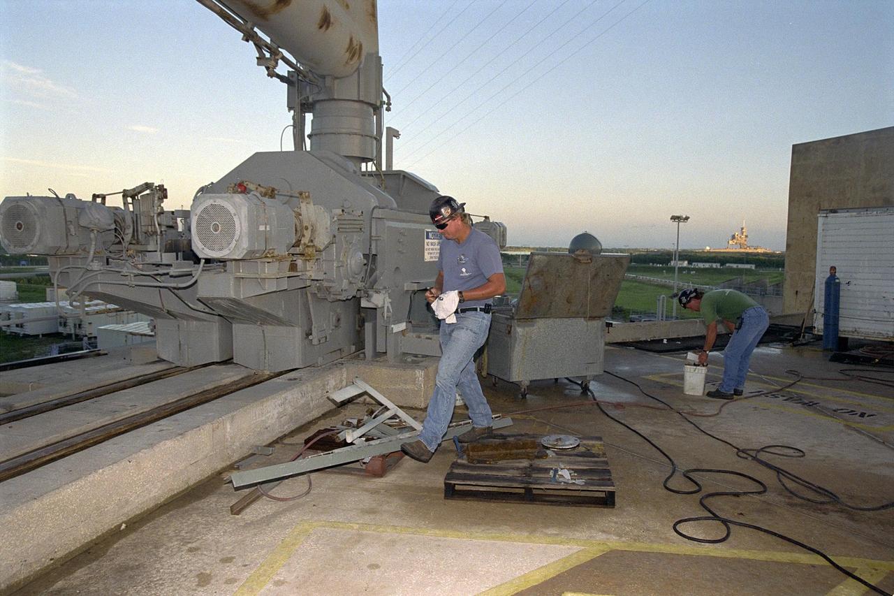 KENNEDY SPACE CENTER, FLA. -- Day in the Life, page 2. Preparing the pad. Workers maintain Pad A at Kennedy Space Center’s Launch Complex 39. Jack Hanover of SDB Engineers and Constructors Inc. prepares to change a bearing in the Rotating Service Structure. This photograph was taken for a special color edition of Spaceport News designed to portray in photographs a single day at KSC, July 26, 2000. The special edition, published Aug. 25, 2000, was created to give readers a look at KSC’s diverse workforce and the critical roles workers play in the nation’s space program. Spaceport News is an official publication of the Kennedy Space Center and is published on alternate Fridays by the Public Affairs Office in the interest of KSC civil service and contractor employees