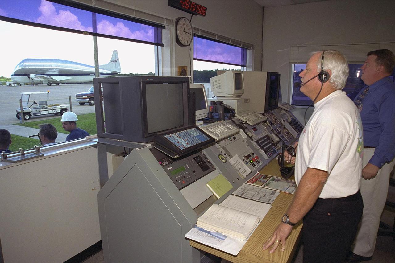 KENNEDY SPACE CENTER, FLA. -- Day in the Life, page 3. Coming in for landing. Inside the control building at the Shuttle Landing Facility, air traffic controller Donny Linton, left, and SGS air facility manager Bob Bryen survey the SLF runway. This photograph was taken for a special color edition of Spaceport News designed to portray in photographs a single day at KSC, July 26, 2000. The special edition, published Aug. 25, 2000, was created to give readers a look at KSC’s diverse workforce and the critical roles workers play in the nation’s space program. Spaceport News is an official publication of the Kennedy Space Center and is published on alternate Fridays by the Public Affairs Office in the interest of KSC civil service and contractor employees