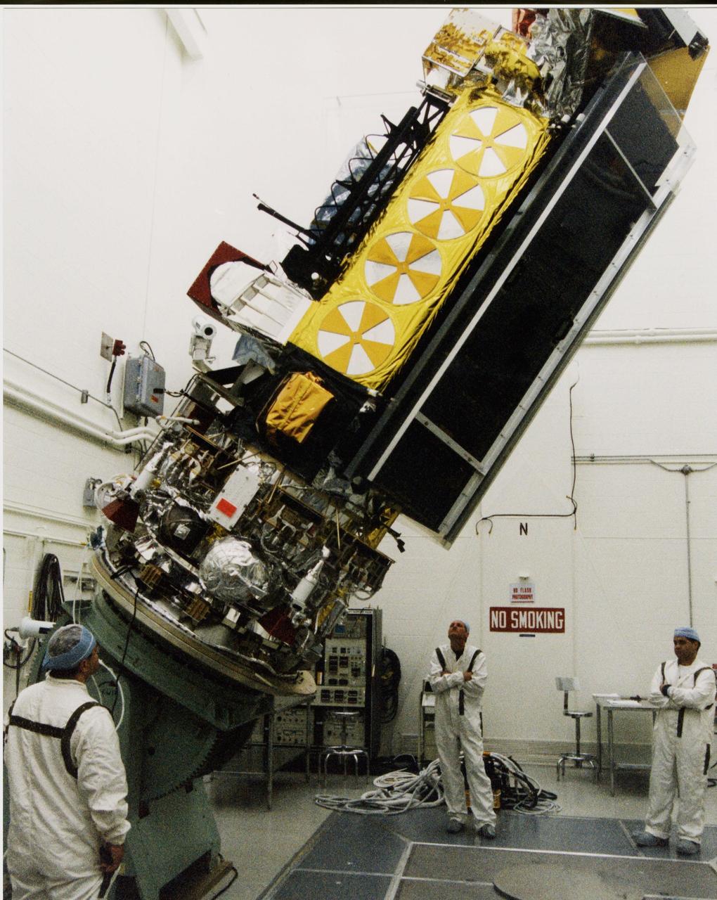 Inside the B16-10 spacecraft processing hangar at Vandenberg Air Force Base, Calif., workers oversee the lifting and rotating of the National Oceanic and Atmospheric Administration (NOAA-L) satellite to allow for mating of the Apogee Kick Motor (AKM). NOAA-L is part of the Polar-Orbiting Operational Environmental Satellite (POES) program that provides atmospheric measurements of temperature, humidity, ozone and cloud images, tracking weather patterns that affect the global weather and climate. The launch of the NOAA-L satellite is scheduled no earlier than Sept. 12 aboard a Lockheed Martin Titan II rocket
