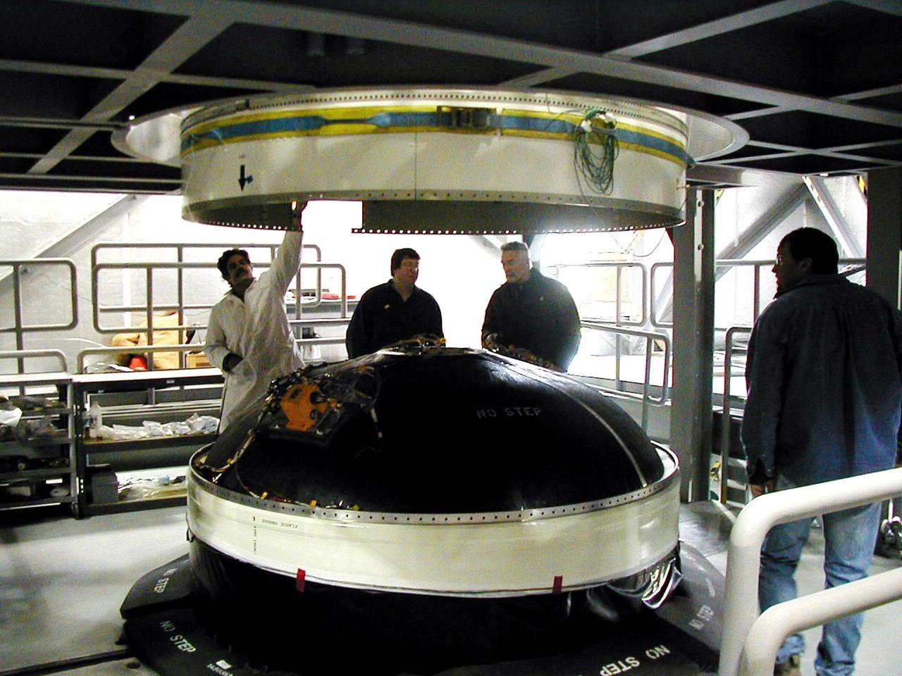 KODIAK ISLAND, Alaska -- Technicians lower the fueled Orbit Adjust Model (OAM), which navigates payloads into the correct orbit, onto Orbis 21D Equipment Section Boost Motor, the second stage of the Athena 1 launch vehicle, at the launch pad at Kodiak Island, Alaska, as preparations to launch Kodiak Star proceed. The first orbital launch to take place from Alaska's Kodiak Launch Complex, Kodiak Star is scheduled to lift off on a Lockheed Martin Athena I launch vehicle on Sept. 17 during a two-hour window that extends from 5 p.m. ADT. The payloads aboard include the Starshine 3, sponsored by NASA, and the PICOSat, PCSat and Sapphire, sponsored by the Department of Defense (DoD) Space Test Program.