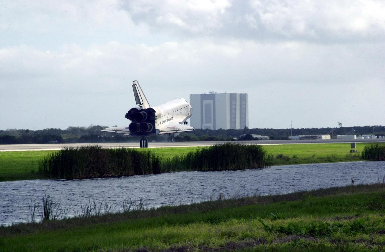 KENNEDY SPACE CENTER, FLA. --  Orbiter Endeavour appears to head toward the Vehicle Assembly Building (background) as it approaches touchdown on Runway 15 at the KSC Shuttle Landing Facility, completing mission STS-108.  After a mission-elapsed time of 11 days, 19 hours and 35 minutes, the landing is the 57th at KSC in the history of the program. Main gear touchdown occurred at 12:55:10 p.m. EST (17:55:10 GMT), nose gear touchdown at 12:55:23 p.m. (17:55:23 GMT) , wheel stop at 12:56:13 p.m. (17:56:13 GMT).   STS-108 was the 12th mission to the International Space Station.  This mission was the 107th flight in the Shuttle program and the 17th flight for the orbiter. Endeavour carries both the mission crew and the Expedition 3 crew - Commander Frank Culbertson and cosmonauts Vladimir Dezhurov and Mikhail Tyurin - who are returning to Earth after 129 days in space on the Space Station