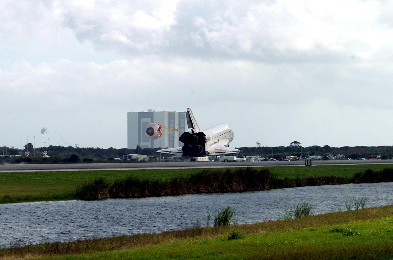 KENNEDY SPACE CENTER, FLA. --  Endeavour's drag chute is deployed as the orbiter touches down on Runway 15 at the KSC Shuttle Landing Facility, completing mission STS-108.  After a mission-elapsed time of 11 days, 19 hours and 35 minutes, the landing is the 57th at KSC in the history of the program. Main gear touchdown occurred at 12:55:10 p.m. EST (17:55:10 GMT), nose gear touchdown at 12:55:23 p.m. (17:55:23 GMT) , wheel stop at 12:56:13 p.m. (17:56:13 GMT).   STS-108 was the 12th mission to the International Space Station.  This mission was the 107th flight in the Shuttle program and the 17th flight for the orbiter. Endeavour carries both the mission crew and the Expedition 3 crew - Commander Frank Culbertson and cosmonauts Vladimir Dezhurov and Mikhail Tyurin - who are returning to Earth after 129 days in space on the Space Station