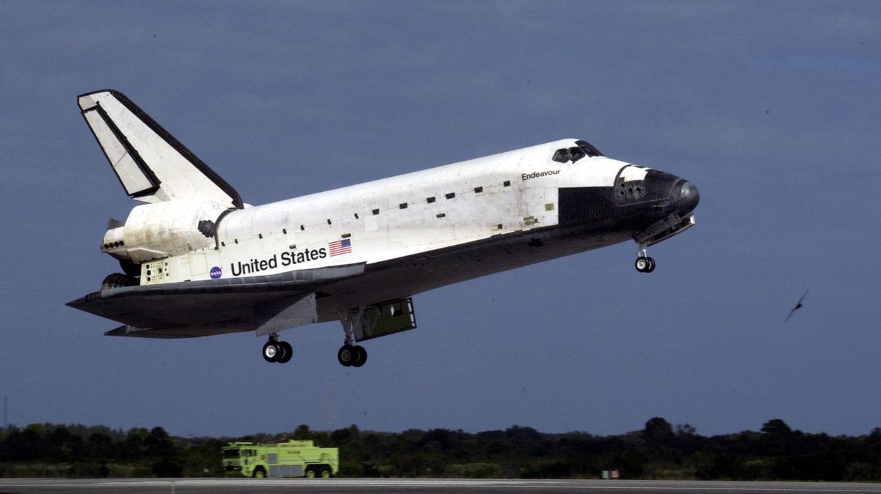 KENNEDY SPACE CENTER, FLA. -- A safety vehicle waits near Runway 15 at the Shuttle Landing Facility as orbiter Endeavour approaches for a landing, completing mission STS-108 after a mission-elapsed time of 11 days, 19 hours and 35 minutes. The landing is the 57th at KSC in the history of the program. Main gear touchdown occurred at 12:55:10 p.m. EST (17:55:10 GMT), nose gear touchdown at 12:55:23 p.m. (17:55:23 GMT) , wheel stop at 12:56:13 p.m. (17:56:13 GMT). STS-108 was the 12th mission to the International Space Station. This mission was the 107th flight in the Shuttle program and the 17th flight for the orbiter. Endeavour carries both the mission crew and the Expedition 3 crew - Commander Frank Culbertson and cosmonauts Vladimir Dezhurov and Mikhail Tyurin - who are returning to Earth after 129 days in space on the Space Station