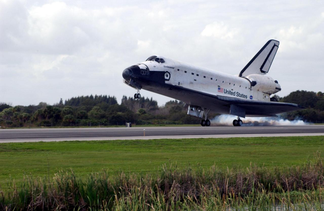 KENNEDY SPACE CENTER, FLA. --  Orbiter Endeavour kicks up dust as it touches down on Runway 15 at the KSC Shuttle Landing Facility, completing mission STS-108. Endeavour carries both the mission crew and the Expedition 3 crew - Commander Frank Culbertson and cosmonauts Vladimir Dezhurov and Mikhail Tyurin - who are returning to Earth after 129 days in space on the International Space Station.  After a mission-elapsed time of 11 days, 19 hours and 35 minutes, Endeavour had main gear touchdown at 12:55:10 p.m. EST (17:55:10 GMT).  Nose gear touchdown occurred at 12:55:23 p.m. (17:55:23 GMT); wheel stop at 12:56:13 p.m. (17:56:13 GMT). Rollout distance was 8,941 feet.  The landing is the 57th at KSC in the history of the program   STS-108 was the 12th mission to the Space Station.  This mission was the 107th flight in the Shuttle program and the 17th flight for the orbiter