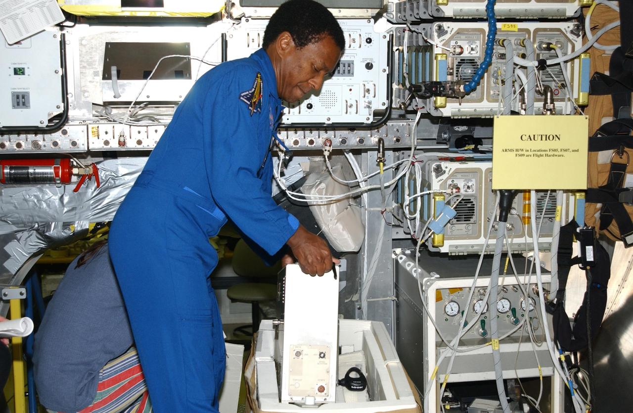 KENNEDY SPACE CENTER, FLA. -- At SPACEHAB in Cape Canaveral, Fla., STS-107 Payload Commander Michael Anderson gets experience on manipulating equipment for the mission. STS-107 is a research mission, and the primary payload is the first flight of the SHI Research Double Module (SHI/RDM). The experiments range from material sciences to life sciences (many rats).  Among the experiments is a Hitchhiker carrier system, modular and expandable in accordance with payload requirements.  STS-107 is scheduled to launch in June 2002